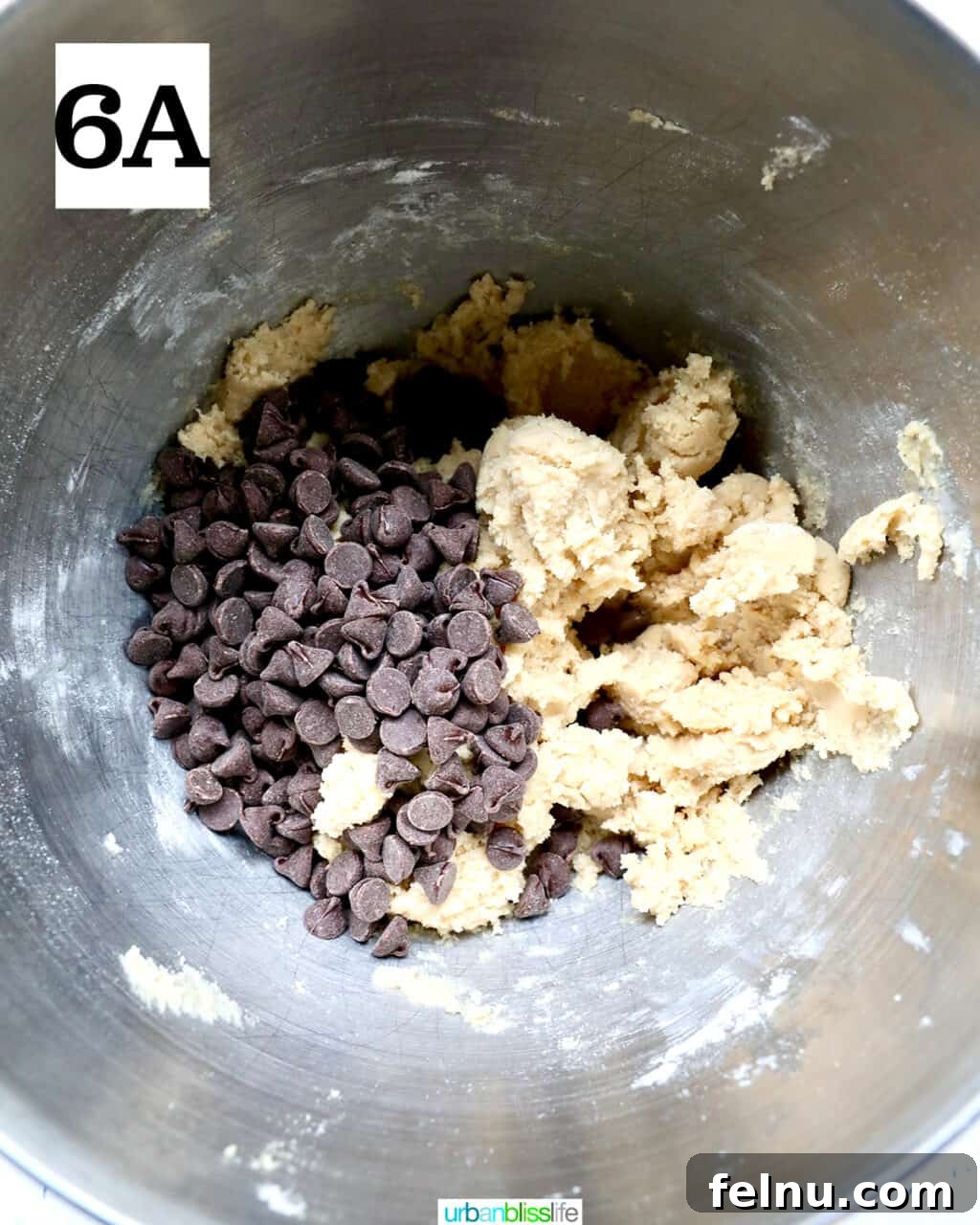 Crispy Air-Fried Delights 12 chocolate chips added to cookie dough in a stand mixer bowl.