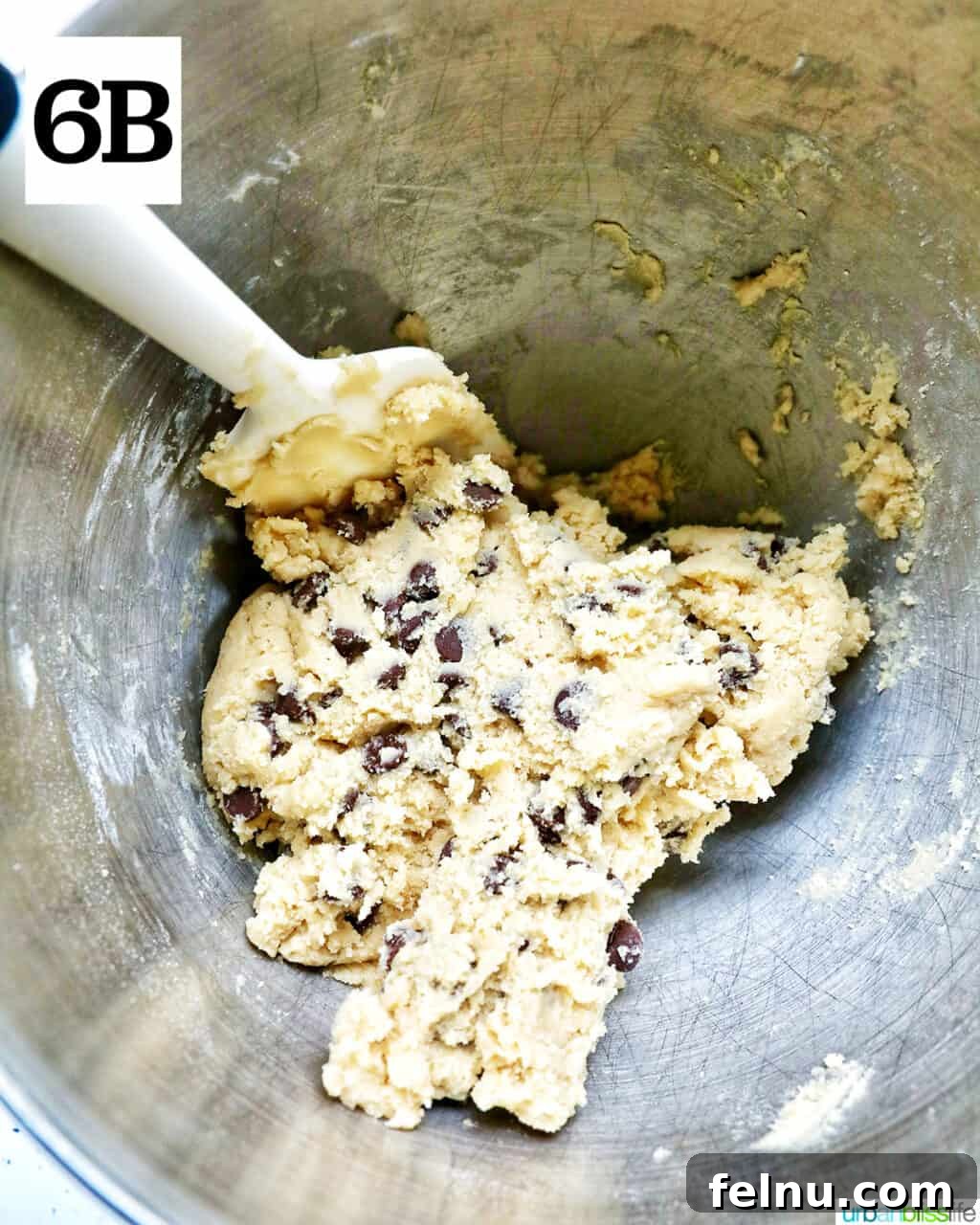 Crispy Air-Fried Delights 13 chocolate chip cookie dough and a spatula in a stand mixer bowl.
