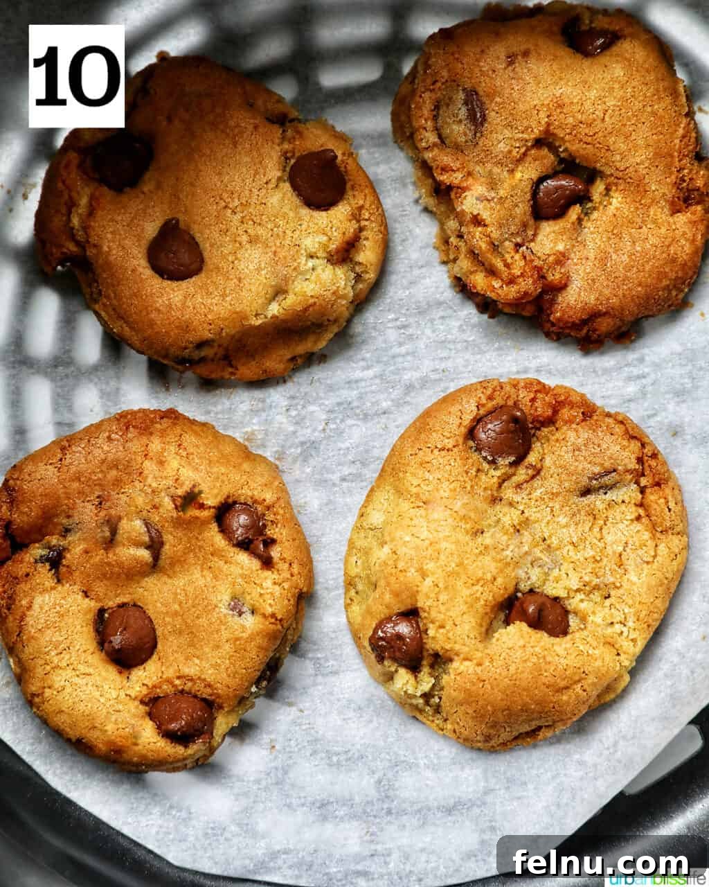 Crispy Air-Fried Delights 17 four chocolate chip cookies baked in an air fryer basket.