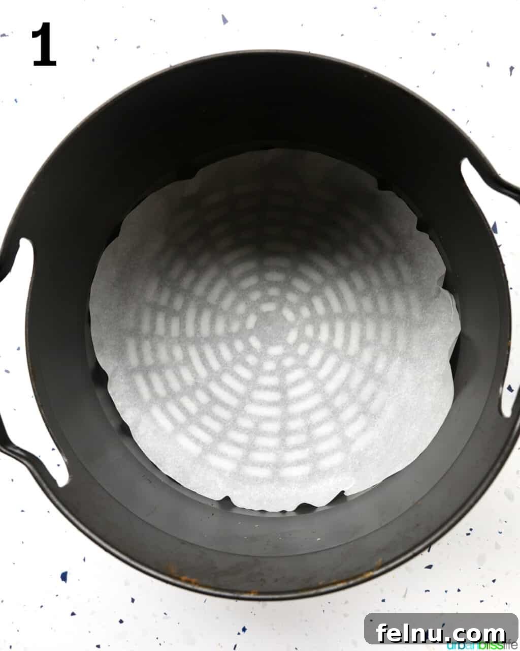 Crispy Air-Fried Delights 5 air fryer basket lined with parchment paper.