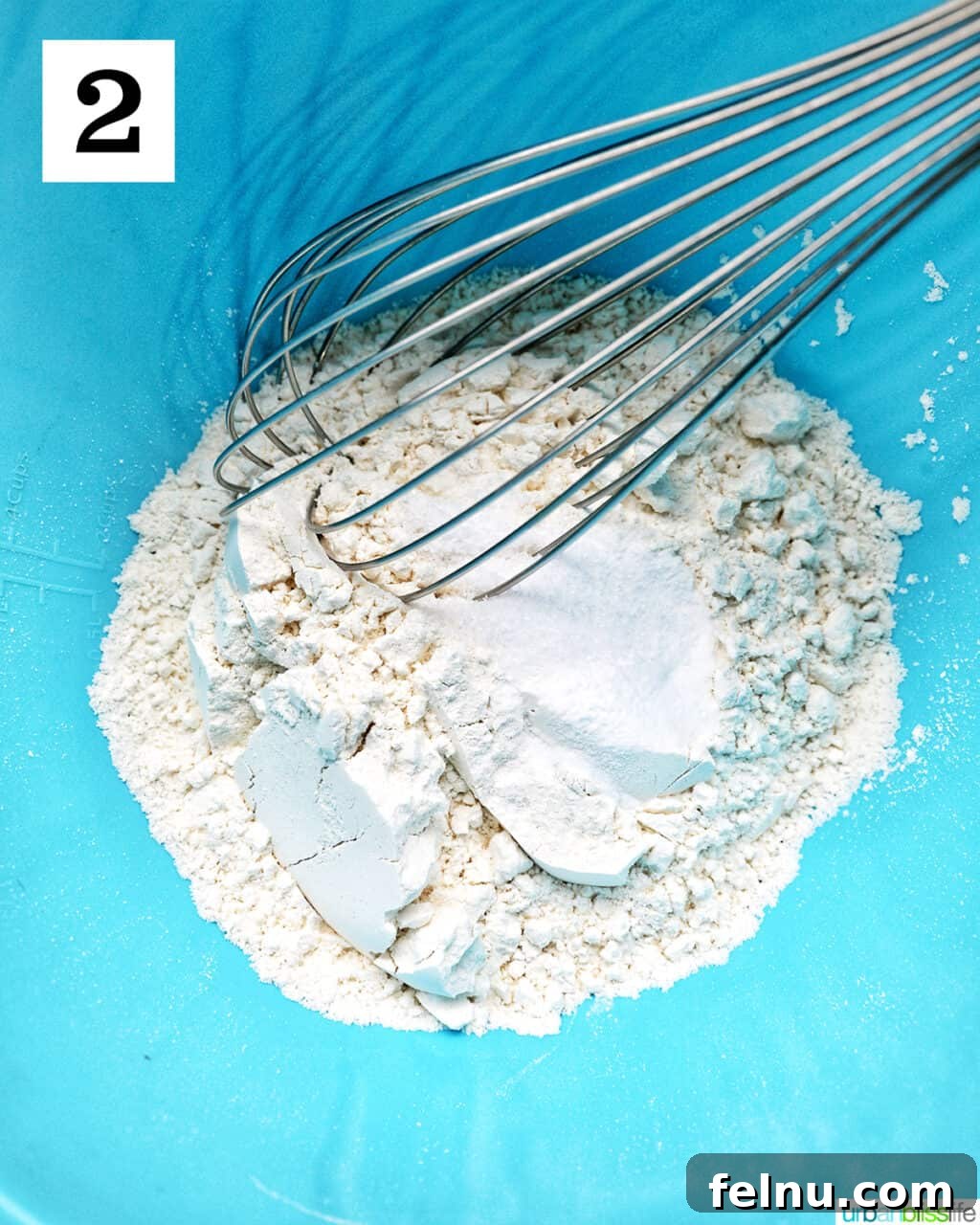 Crispy Air-Fried Delights 6 whisk in dry ingredients in a blue bowl.