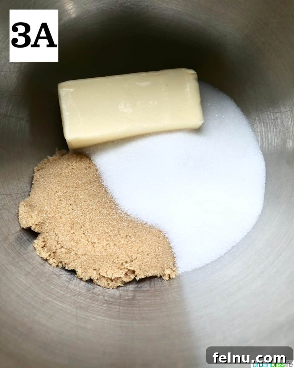 Crispy Air-Fried Delights 7 stick of butter, granulated sugar, and brown sugar in a stainless steel bowl.