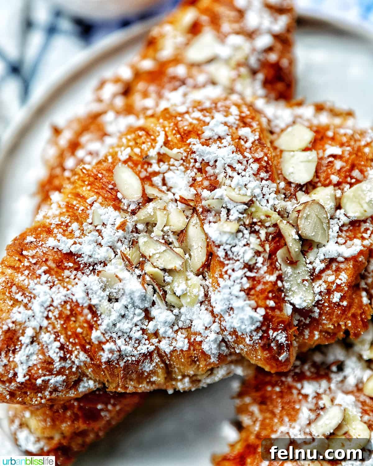 Delicious almond croissants on a plate, ready to be enjoyed.