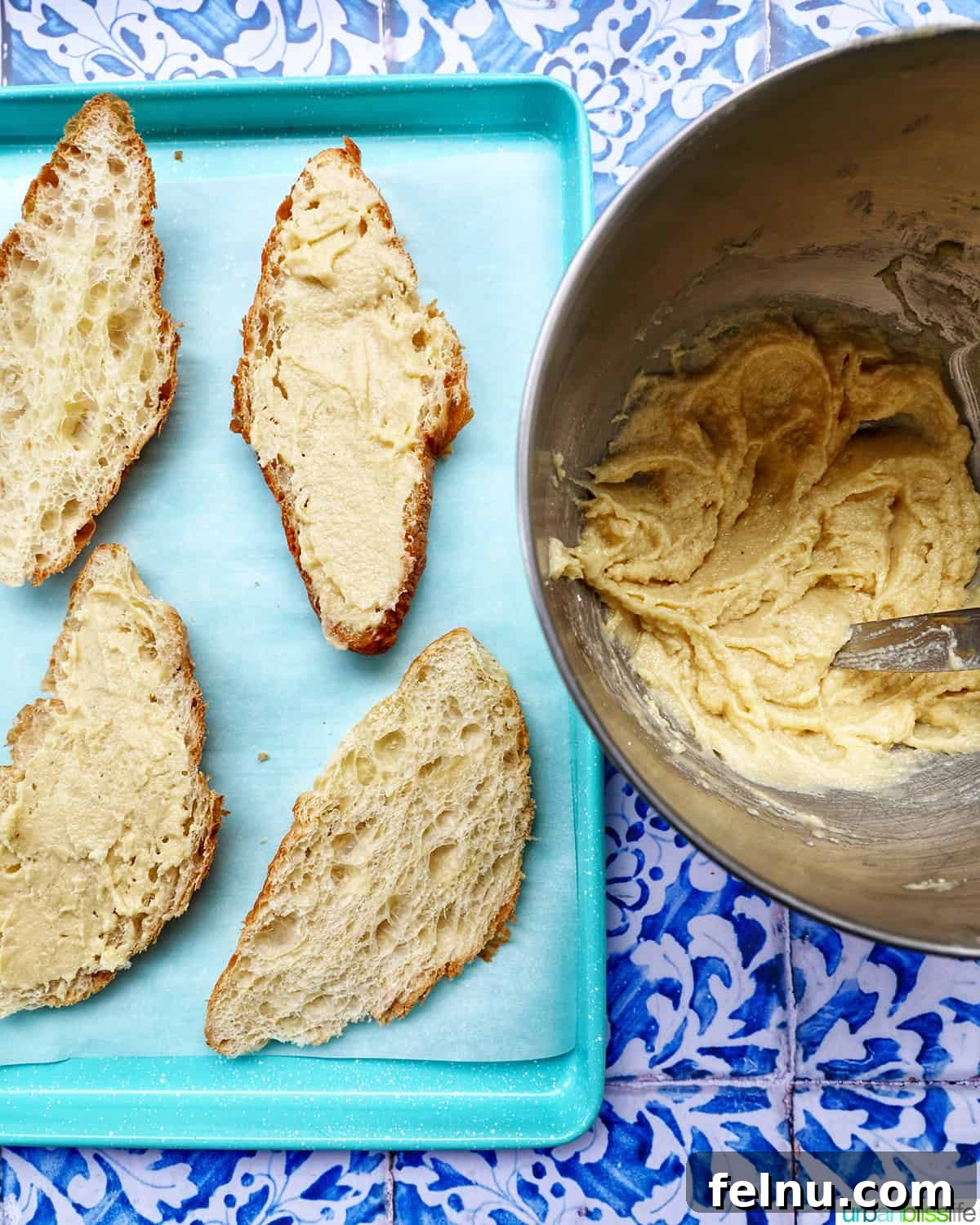 A close-up shot of almond croissants during assembly, highlighting the frangipane filling.