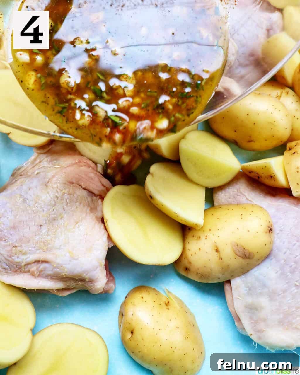 Tek Tepside Tavuklu Patates 9 seasoning pouring over raw chicken and potatoes.
