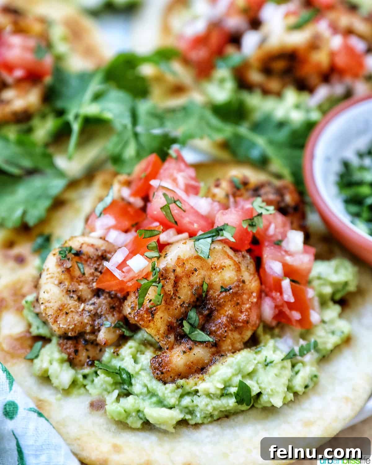 Shrimp tostada with pico de gallo, shrimp, and guacamole.