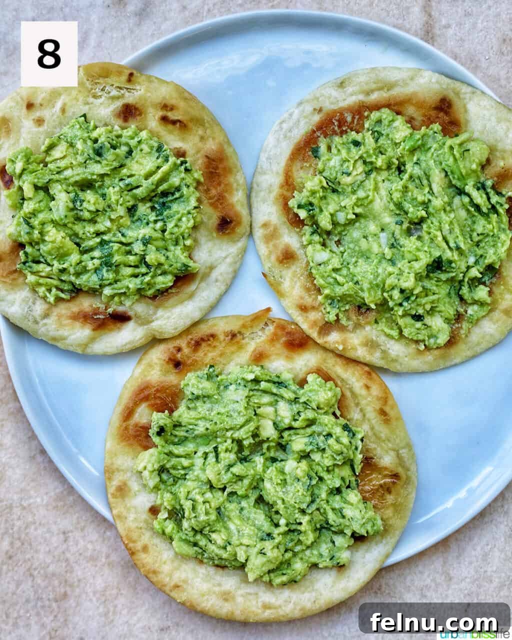 Tortillas topped with guacamole.