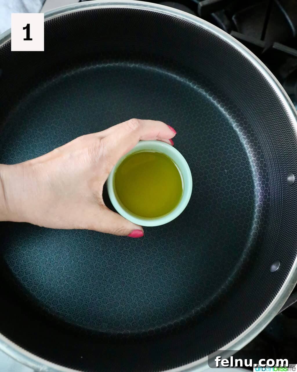 Adding olive oil to a pan.