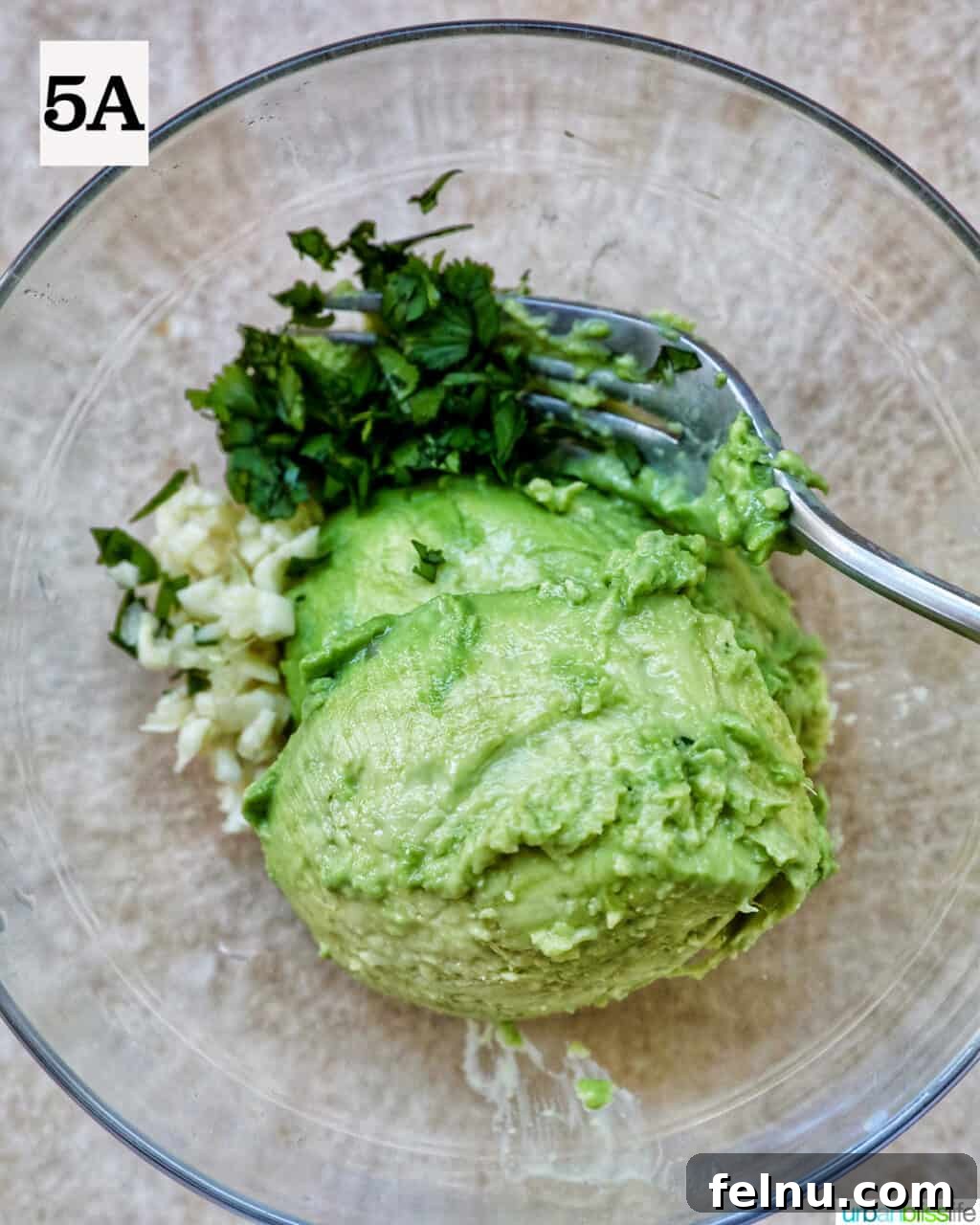 Ingredients for guacamole in a bowl.