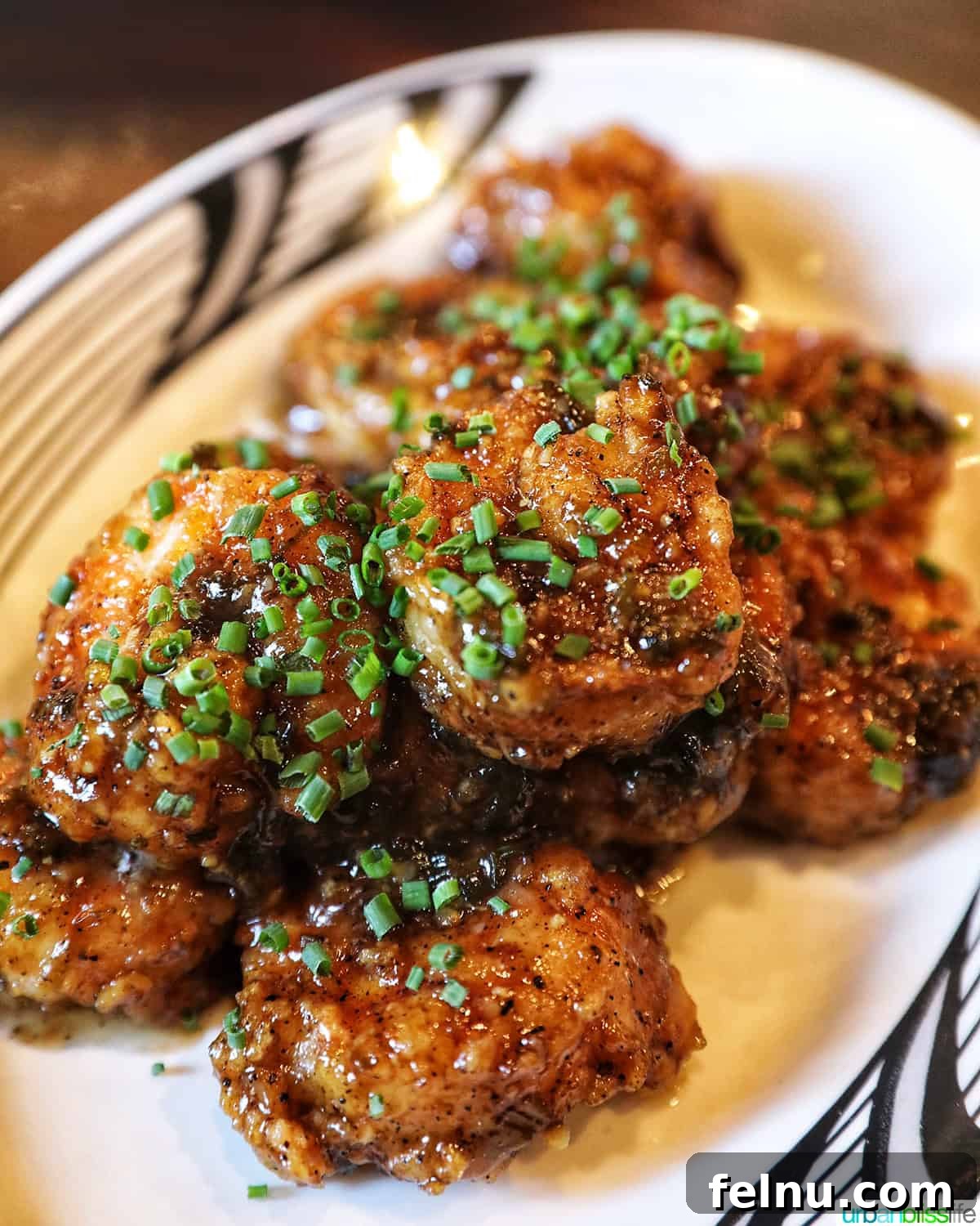 Warsugai Restaurant 10 A close-up shot of crispy Kampong Shrimp coated in a sweet and tangy glaze, garnished with tiny scallions.
