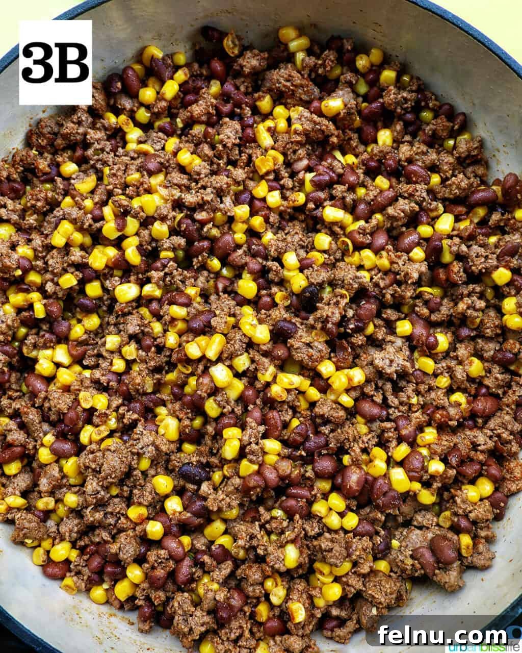 Effortless Fiesta Bowls 8 Ground beef, beans, and corn cooking in a pan.