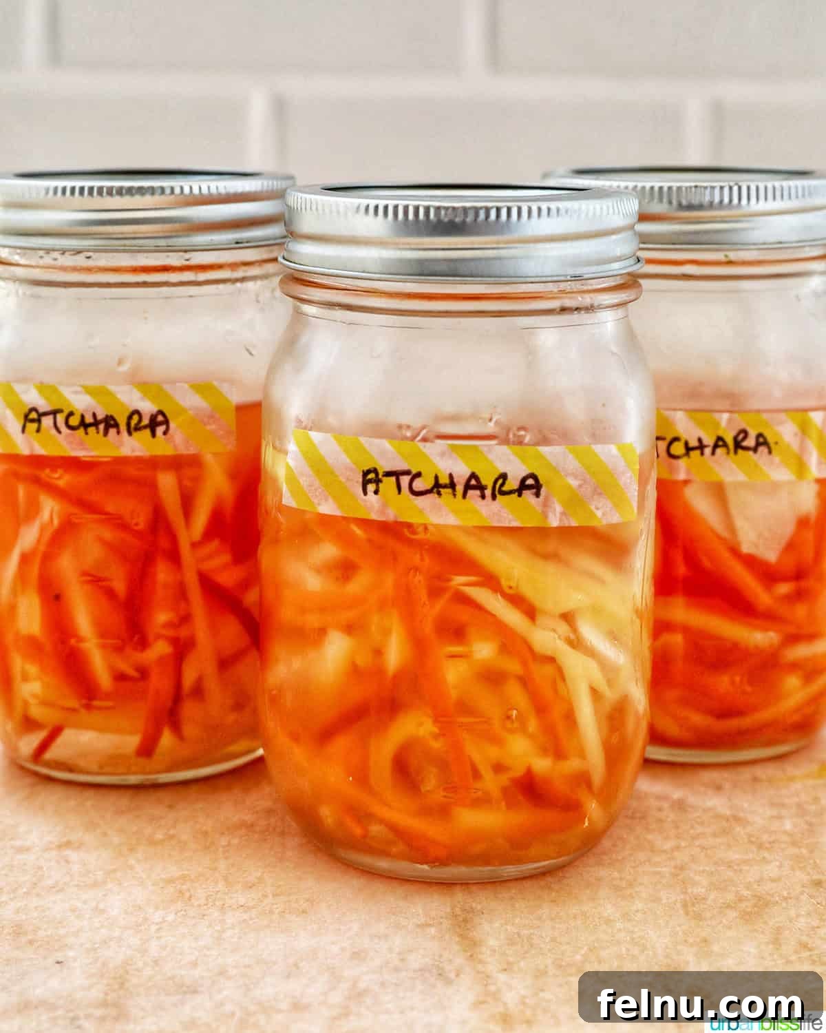 Filipino Atchara: Sweet and Sour Papaya Pickle 14 Three mason jars filled with homemade Filipino Atchara, ready for enjoyment.