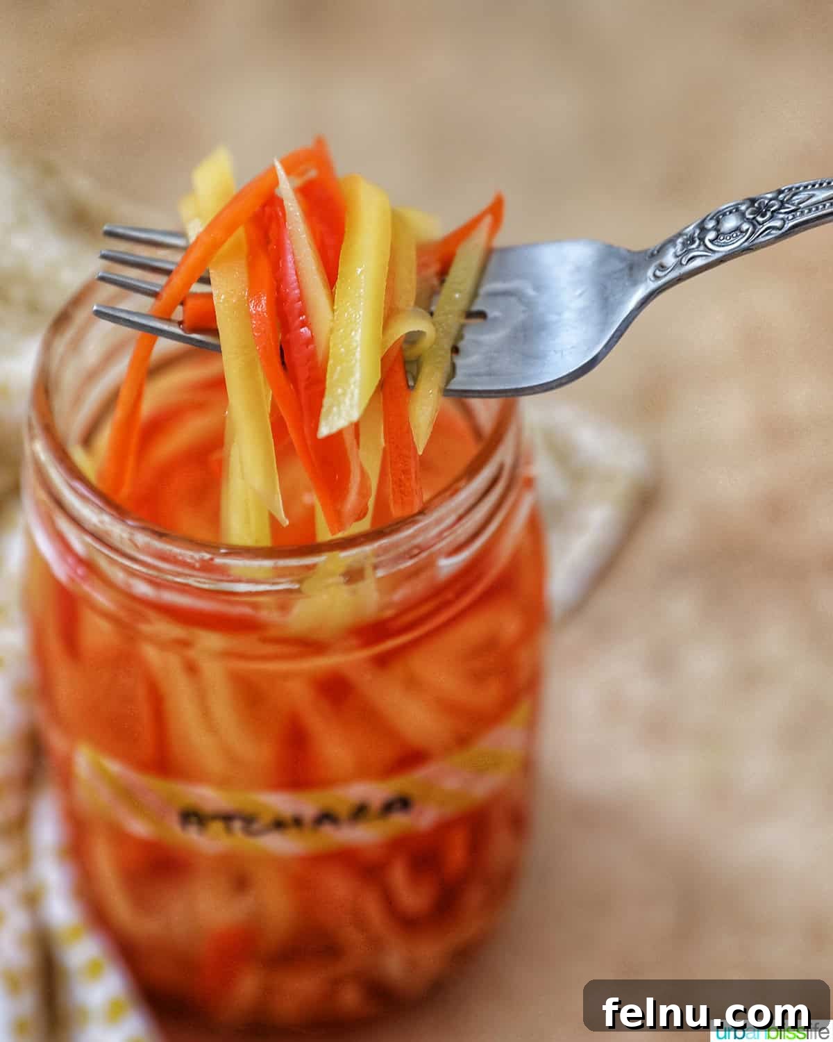 Filipino Atchara: Sweet and Sour Papaya Pickle 15 A forkful of vibrant Filipino Atchara held over a mason jar, ready to be served.