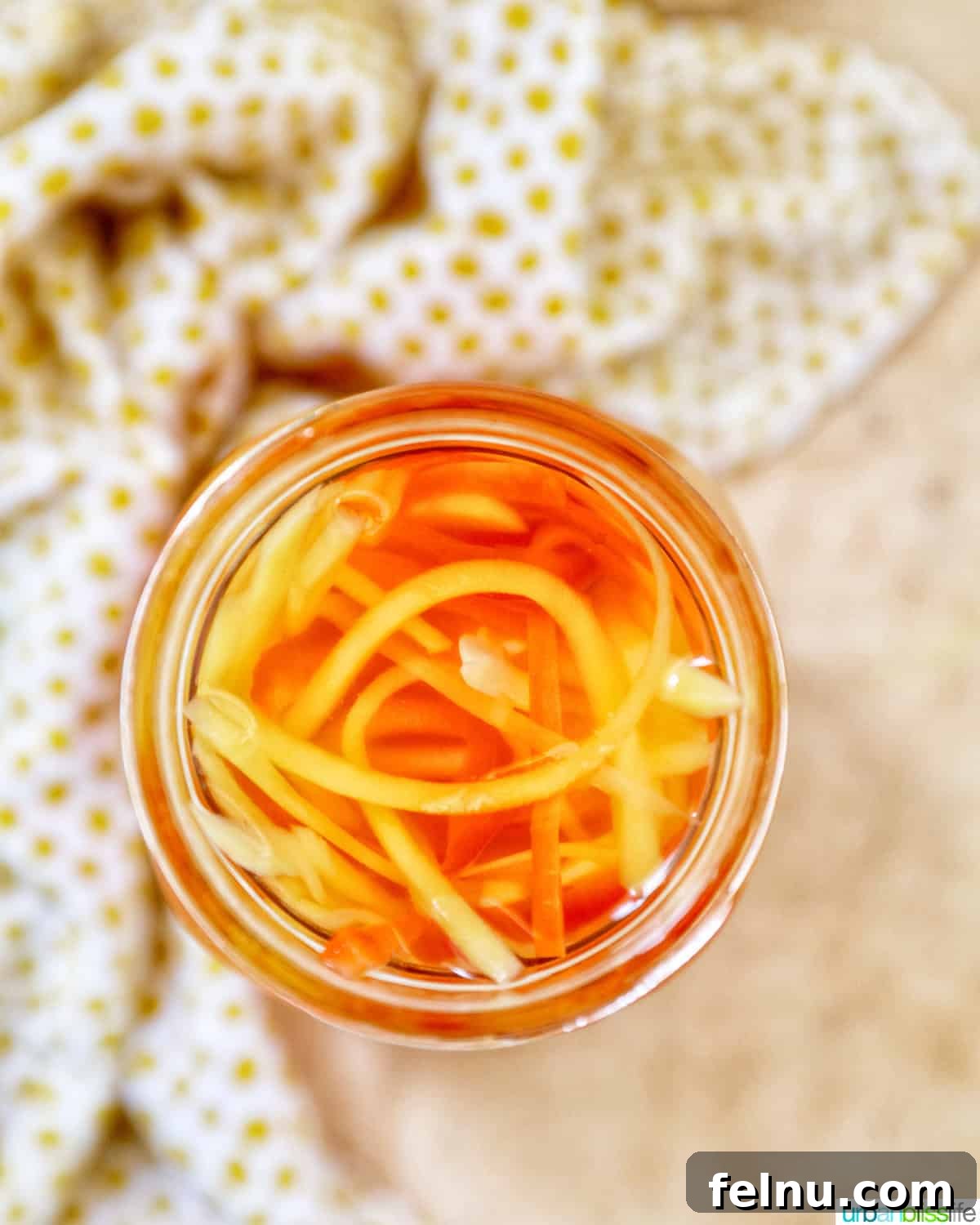 Filipino Atchara: Sweet and Sour Papaya Pickle 16 Single mason jar filled with Filipino Atchara, shown with a clear background.