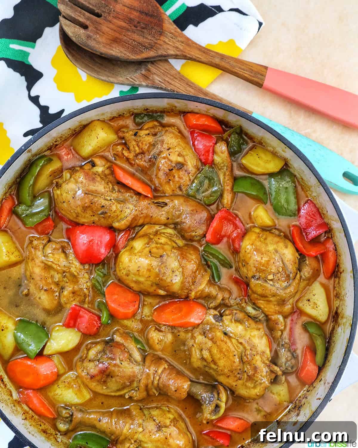 Filipino Chicken Curry
Authentic Chicken Adobo Curry Fusion 21 Filipino Chicken Curry with vegetables in a large pan with wooden utensils.