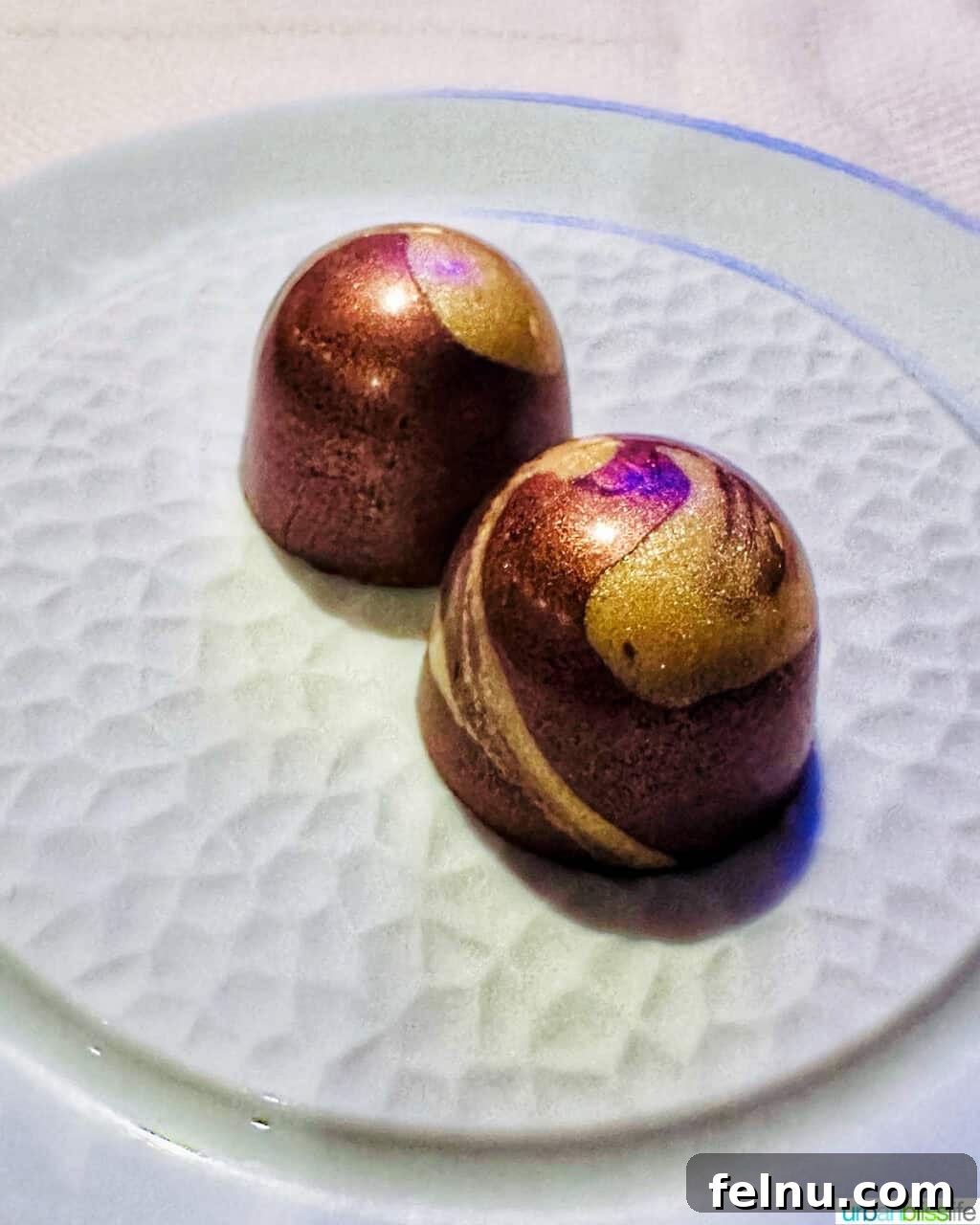 Two chocolate truffles on a plate at Marea restaurant New York City (NYC).