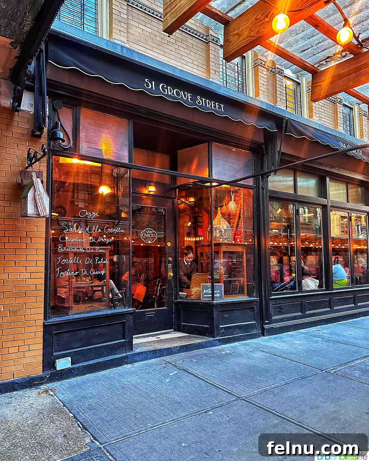 Via Carota NYC: West Village's Authentic Italian Experience 2 The charming exterior of Via Carota, an Italian restaurant in New York City's West Village, inviting diners with its warm glow.