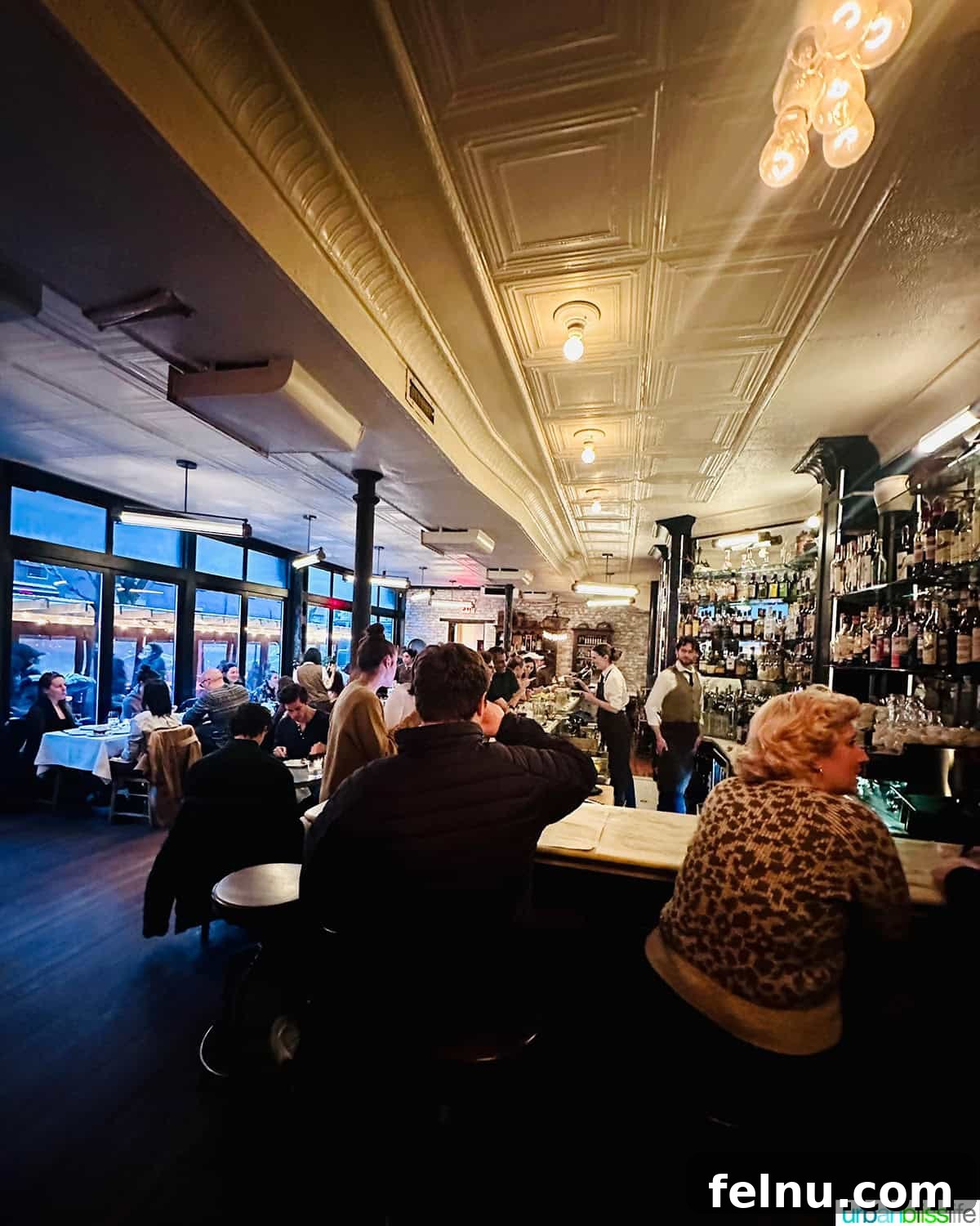 Via Carota NYC: West Village's Authentic Italian Experience 3 The inviting interior of Via Carota restaurant, showcasing its warm lighting and rustic decor, promising a cozy dining experience.
