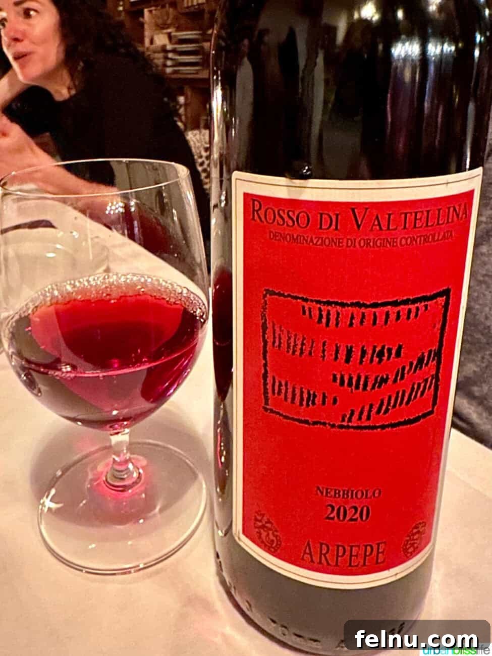 Via Carota NYC: West Village's Authentic Italian Experience 4 A bottle and glass of rich Nebbiolo wine, perfectly paired with the ambiance of Via Carota restaurant.