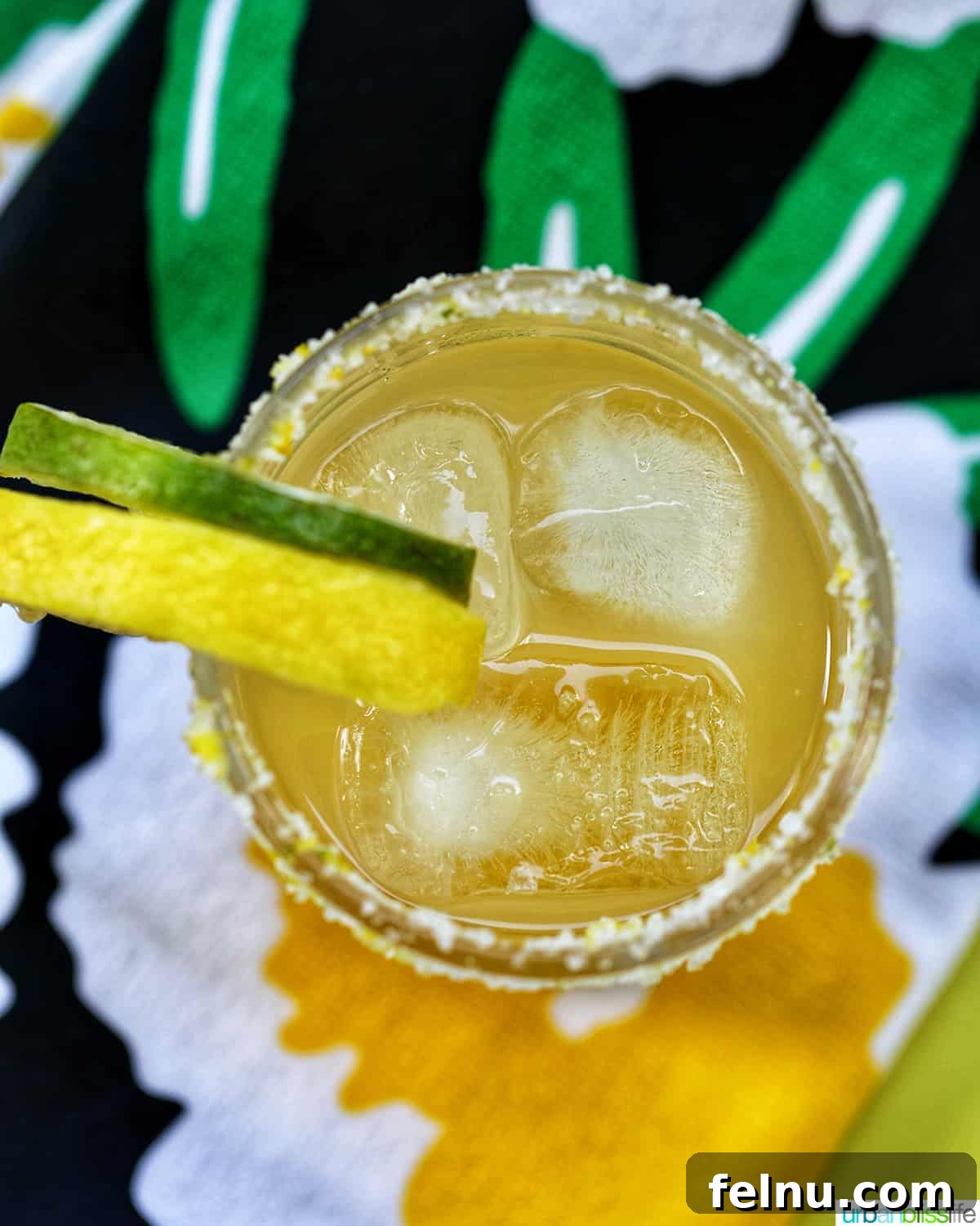 Zesty Yuzu Margarita 8 A stunning Yuzu Margarita presented in a classic glass, adorned with lemon and lime slices, positioned on vibrant, inviting napkins.