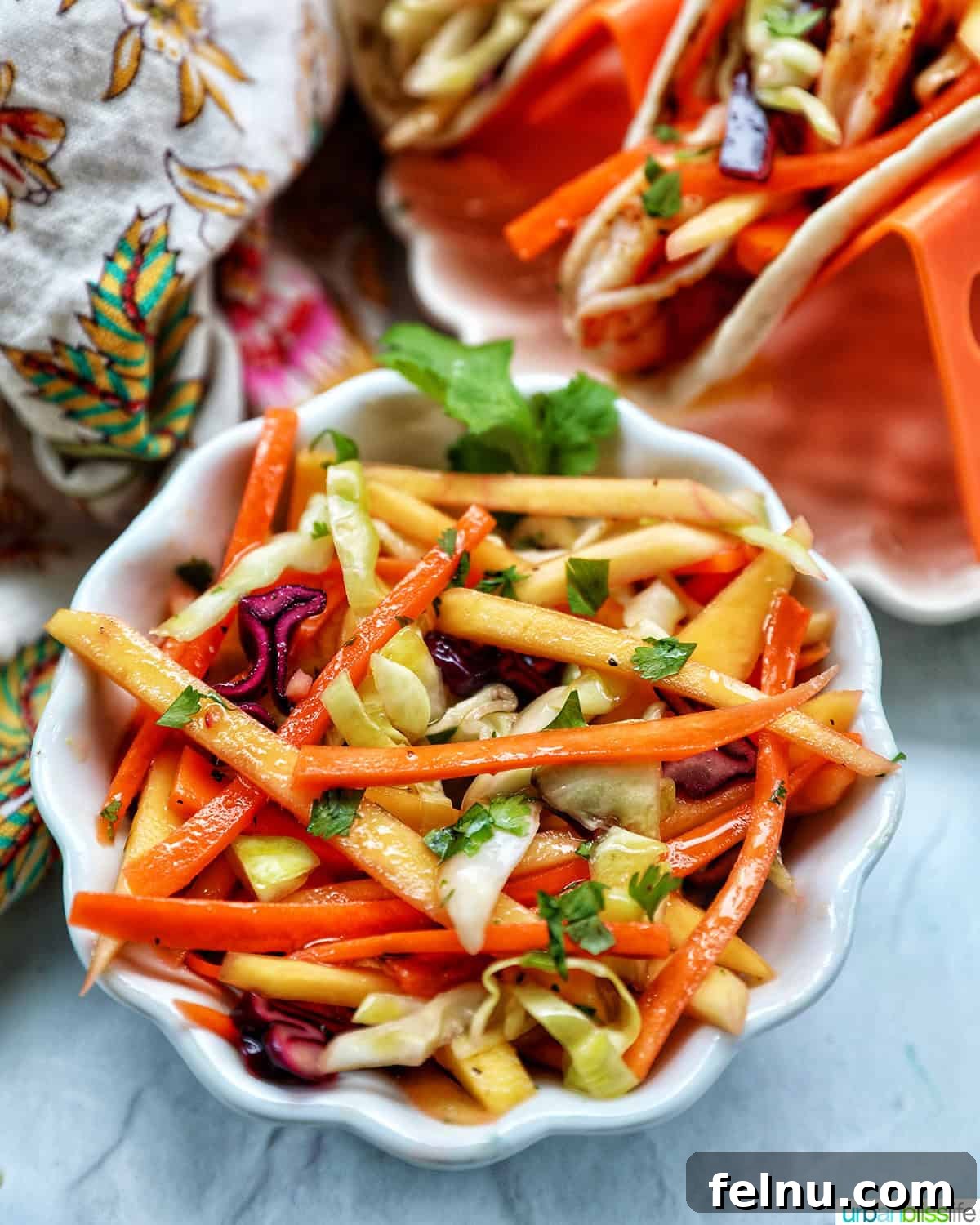 Mango Coleslaw 3 Bowl of mango slaw with side of shrimp tacos.