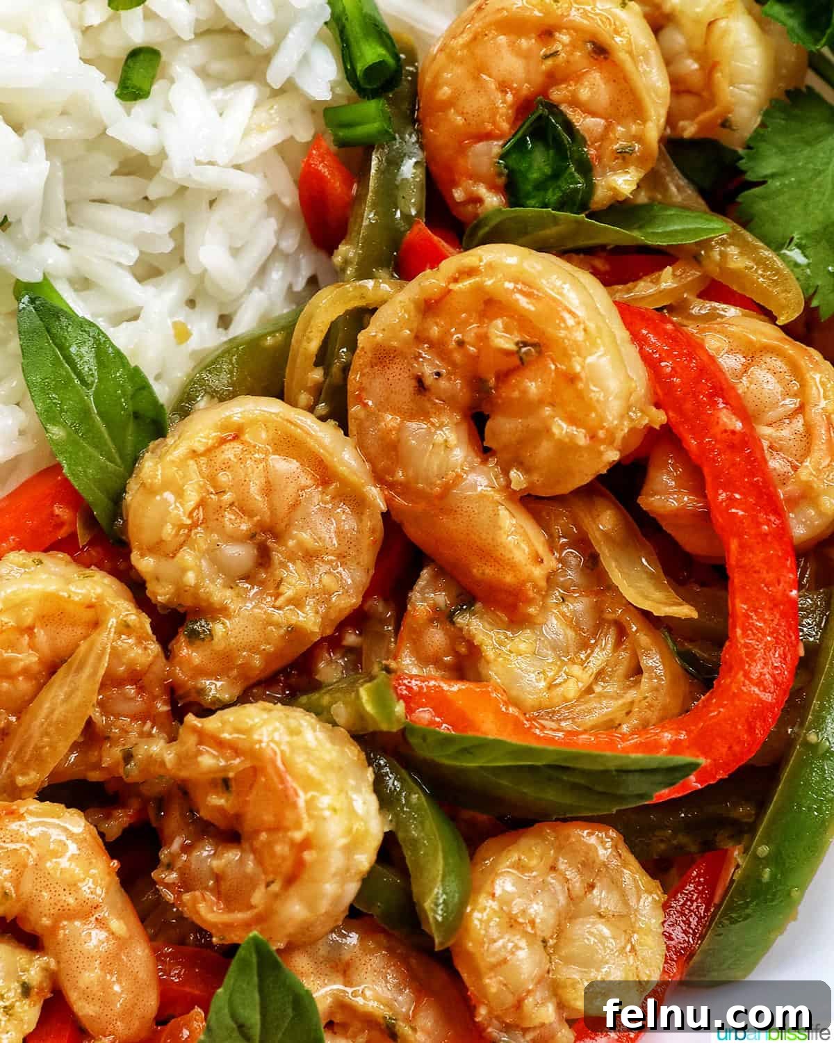 Must-Try Thai Dishes 20 Thai Basil Shrimp with red and green peppers on a bed of rice.