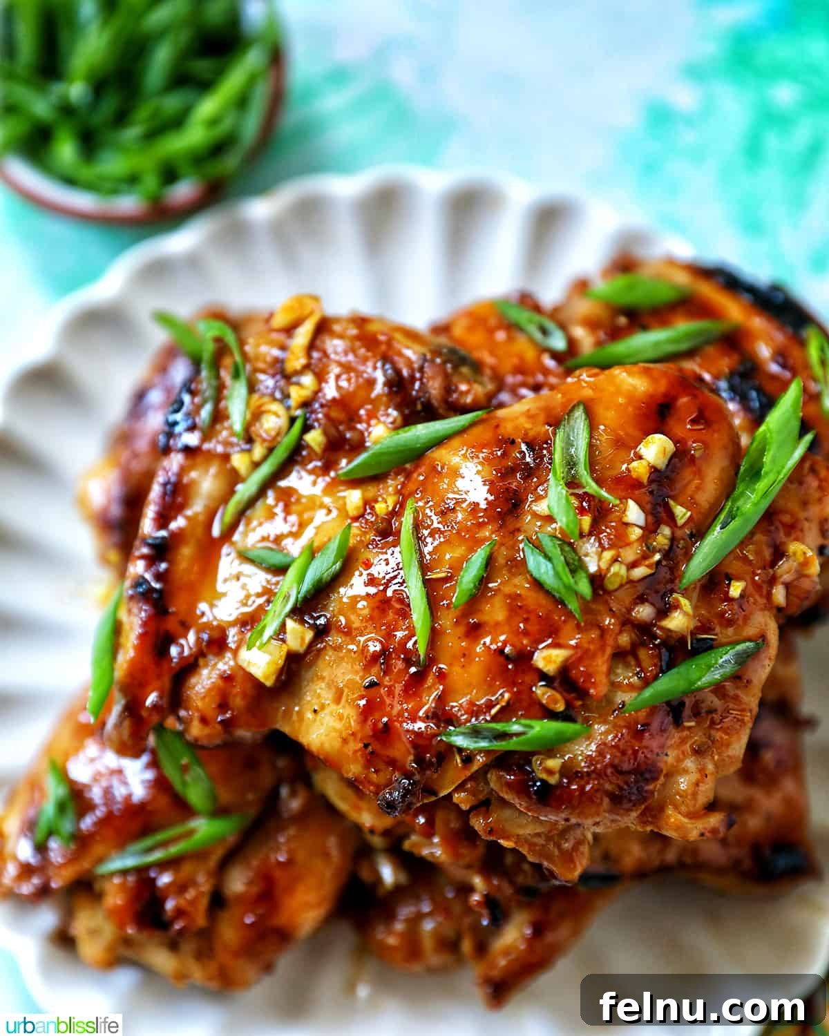 Must-Try Thai Dishes 21 Plate with a stack of Thai Lemongrass Chicken and sliced green onion garnish.