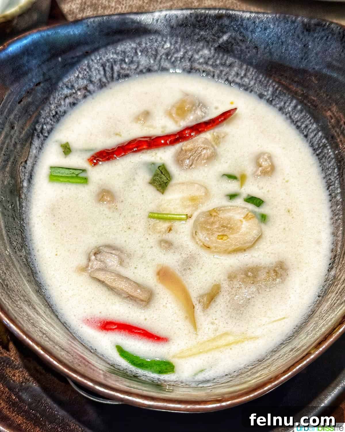 Must-Try Thai Dishes 8 bowl of Tom Kha Gai coconut chicken soup.