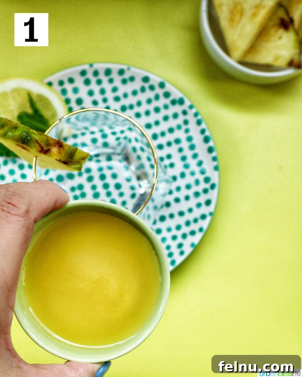 Pouring pineapple juice into a glass.