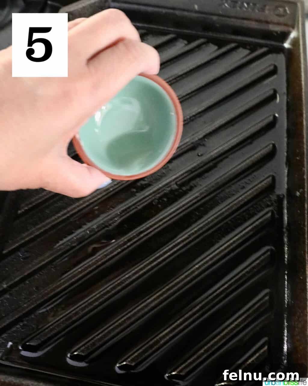 Hawaiian Grilled Chicken with Pineapple Glaze 9 Hand pouring oil over a grill pan
