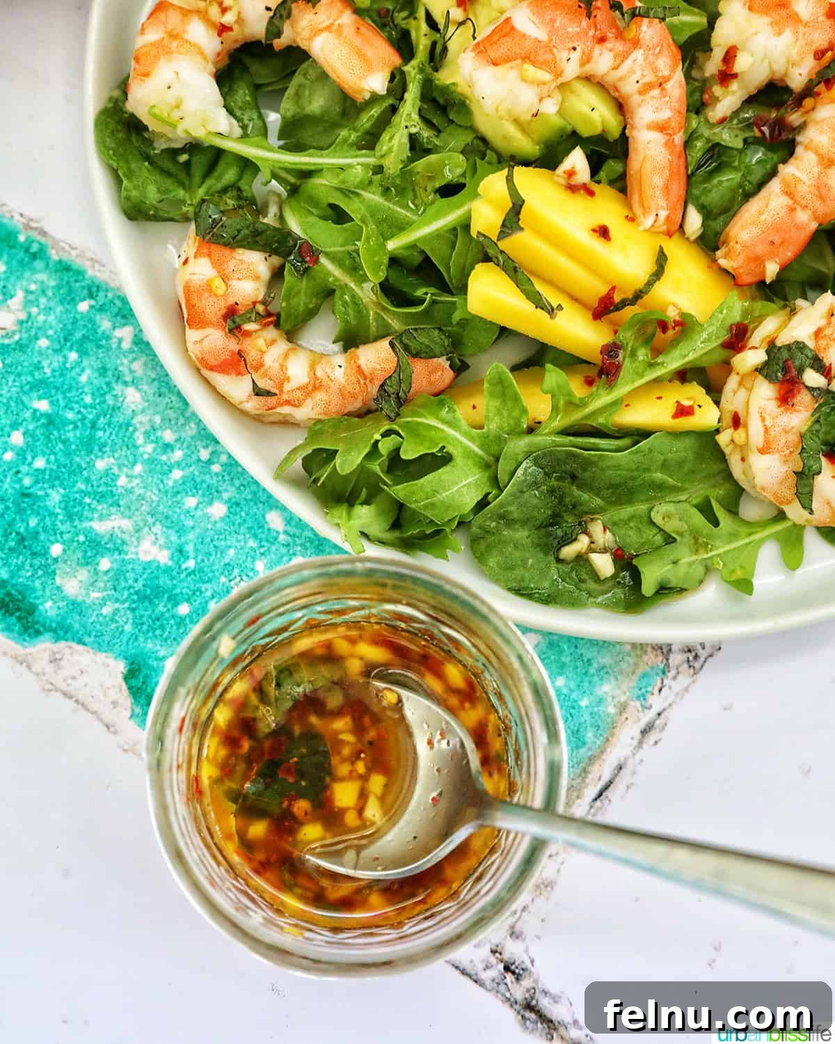 Mango Avocado Shrimp Salad 13 Mango Avocado Prawn Salad alongside a jar of homemade chili lime vinaigrette