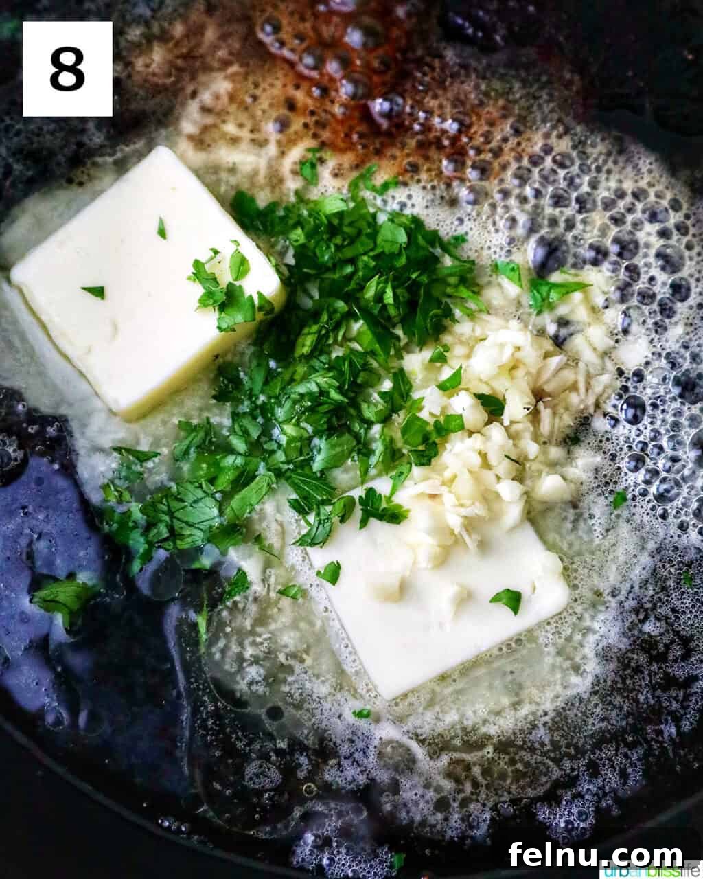 Butter, garlic, and herbs in a cast iron skillet.