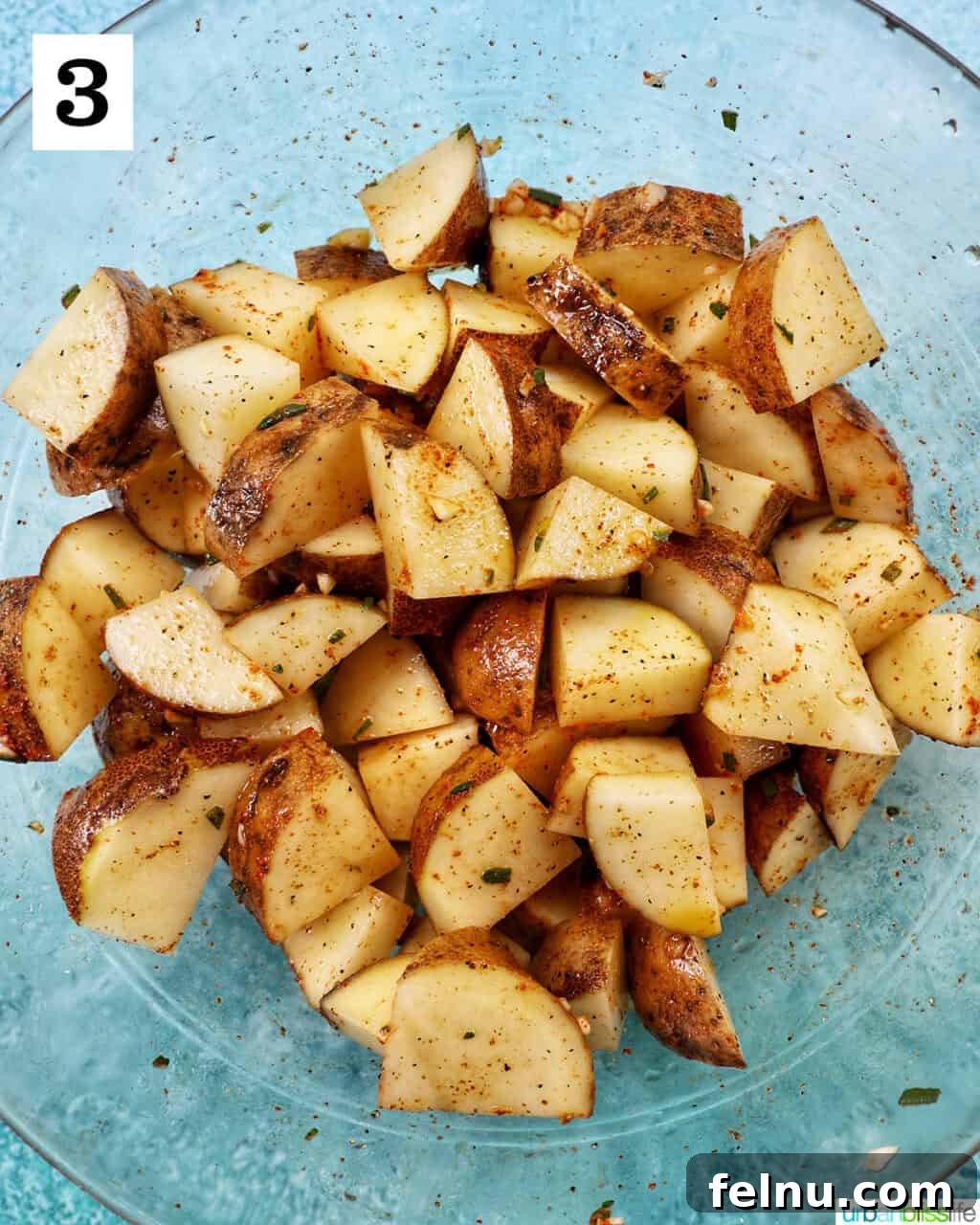 Crispy Rosemary Garlic Potatoes 7 glass bowl with potato wedges.