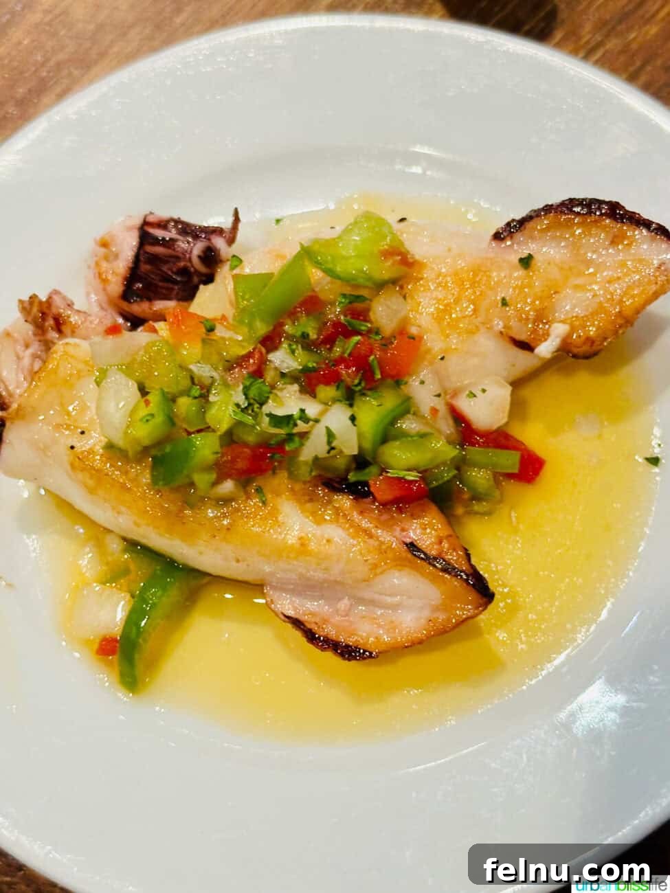 Savoring San Sebastian's Finest Pintxos 18 Grilled squid pintxo, showcasing the fresh seafood offerings of San Sebastian's pintxos bars.