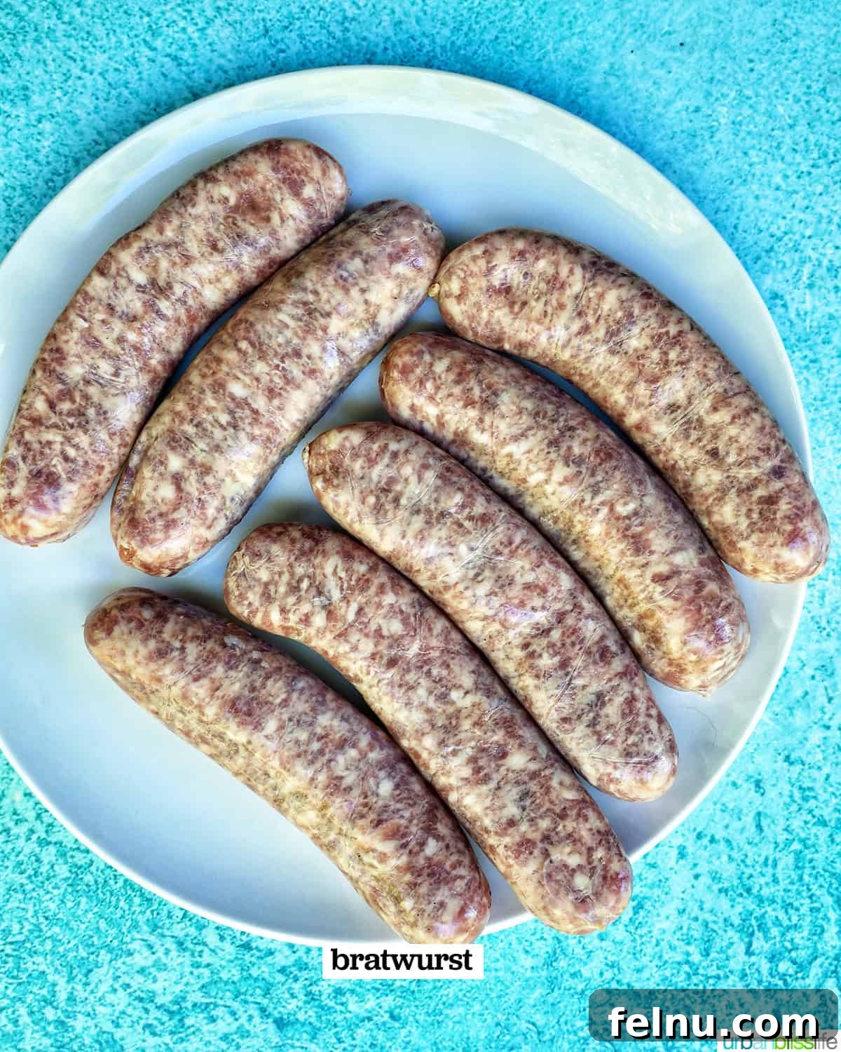 Grilled Bratwurst Bliss 4 Uncooked bratwurst on a plate