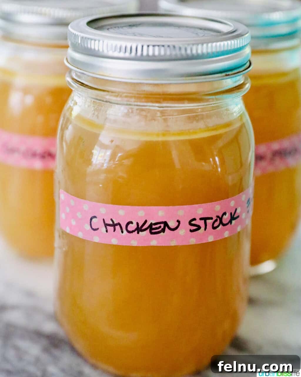 Mason jars filled with homemade chicken stock