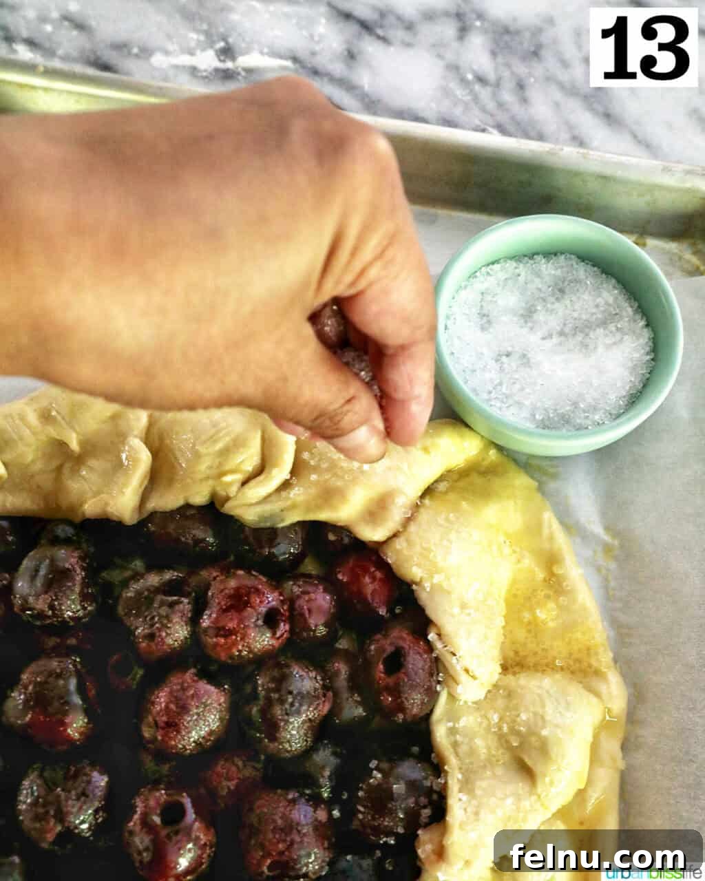 Cherry Bliss Galette 17 Sprinkling sanding sugar over the galette
