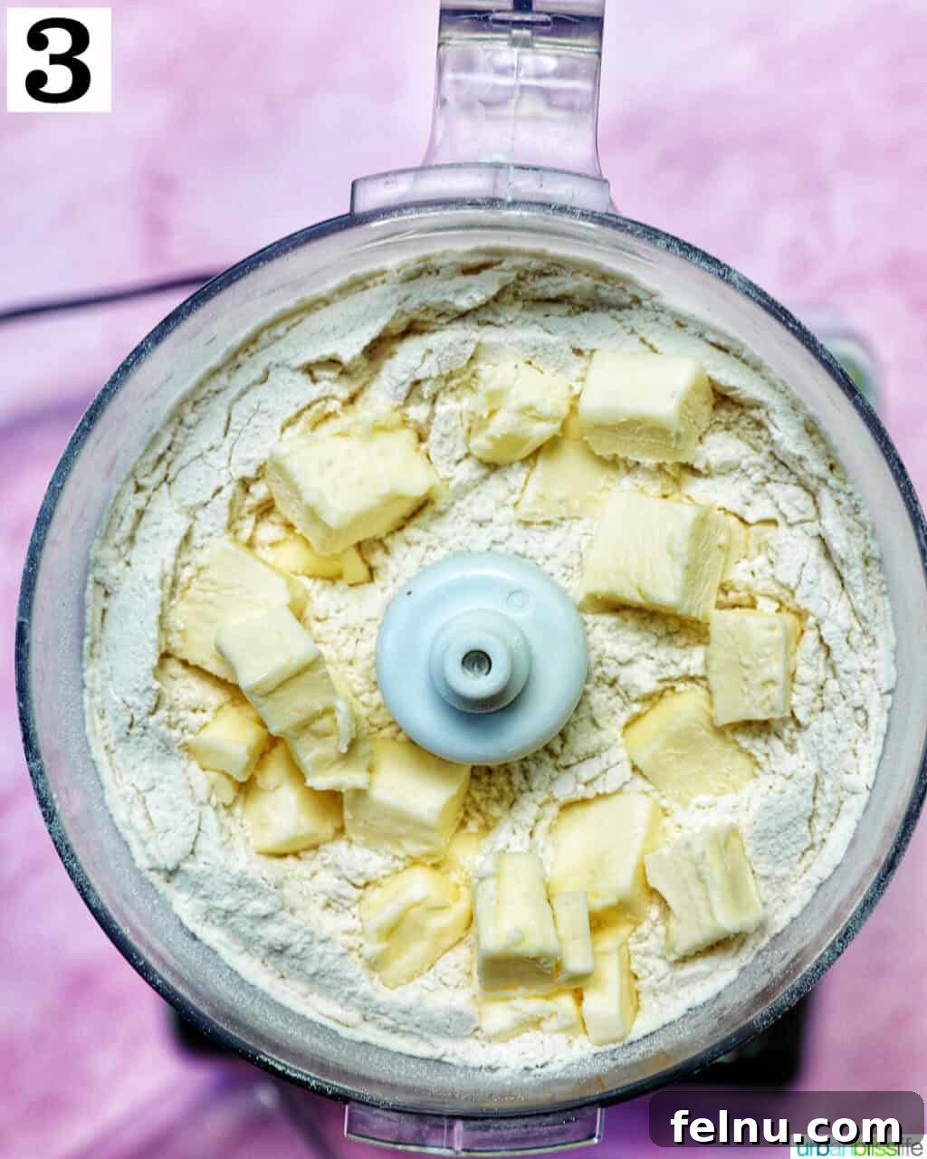 Butter added to pie dough in a food processor