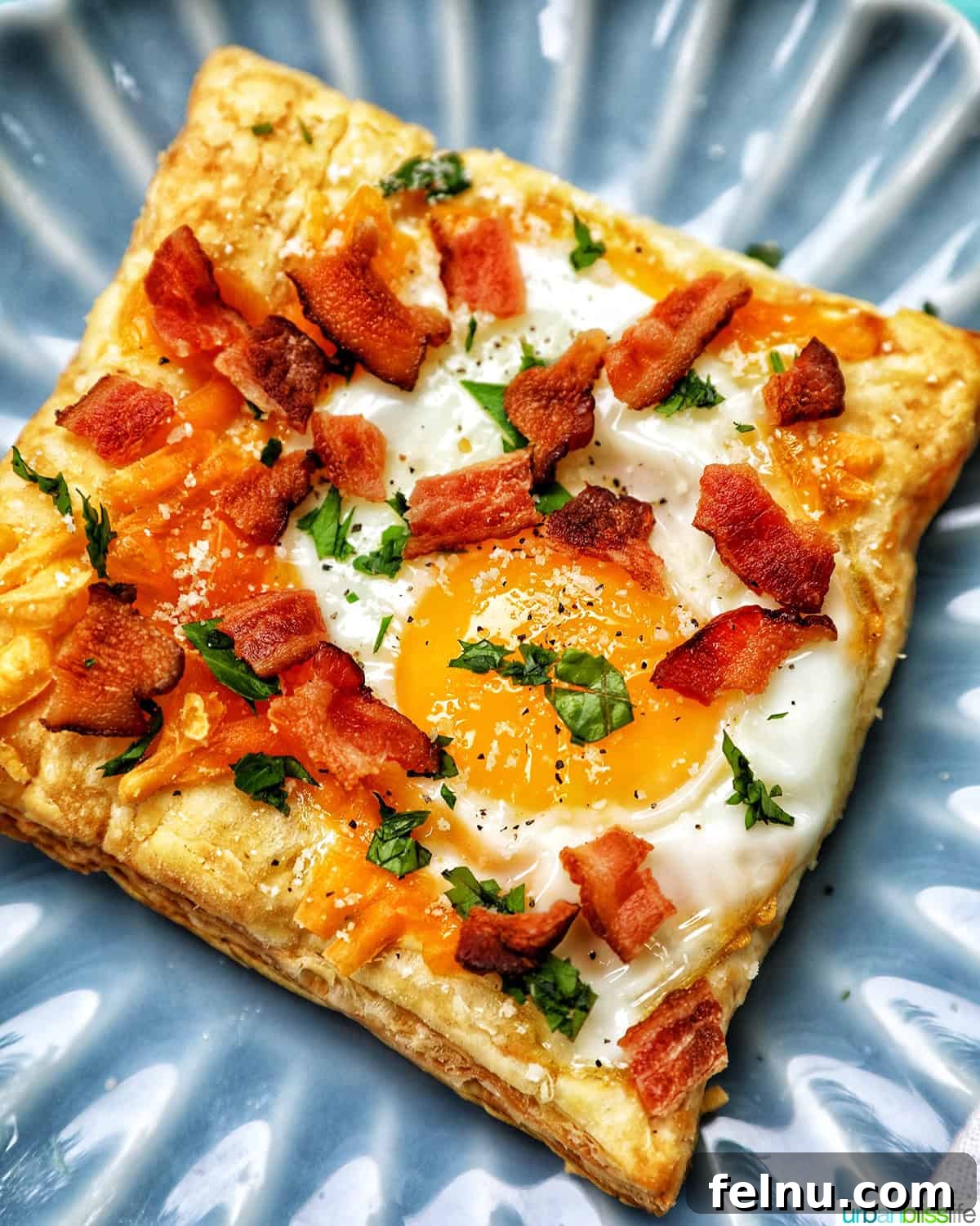 Golden Egg Parcels 18 Egg in puff pastry topped with crispy bacon crumbles and parsley, served on a plate.