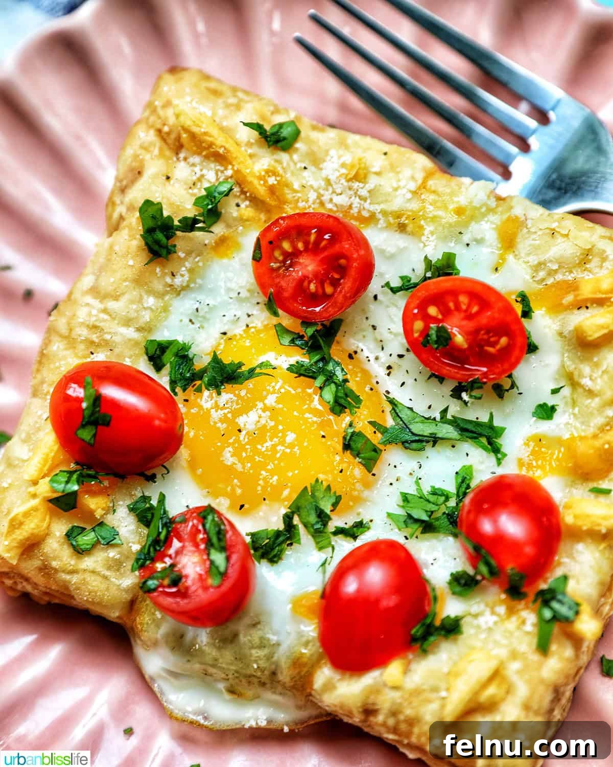 Golden Egg Parcels 3 Two plates of egg in puff pastry, one with tomatoes and parsley, the other with plain parsley garnish.