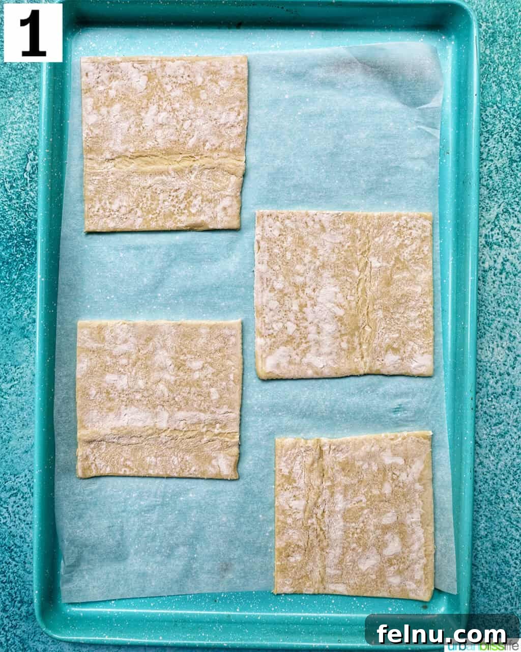 Golden Egg Parcels 5 Puff pastry squares arranged on a parchment paper-lined baking sheet, ready for baking.