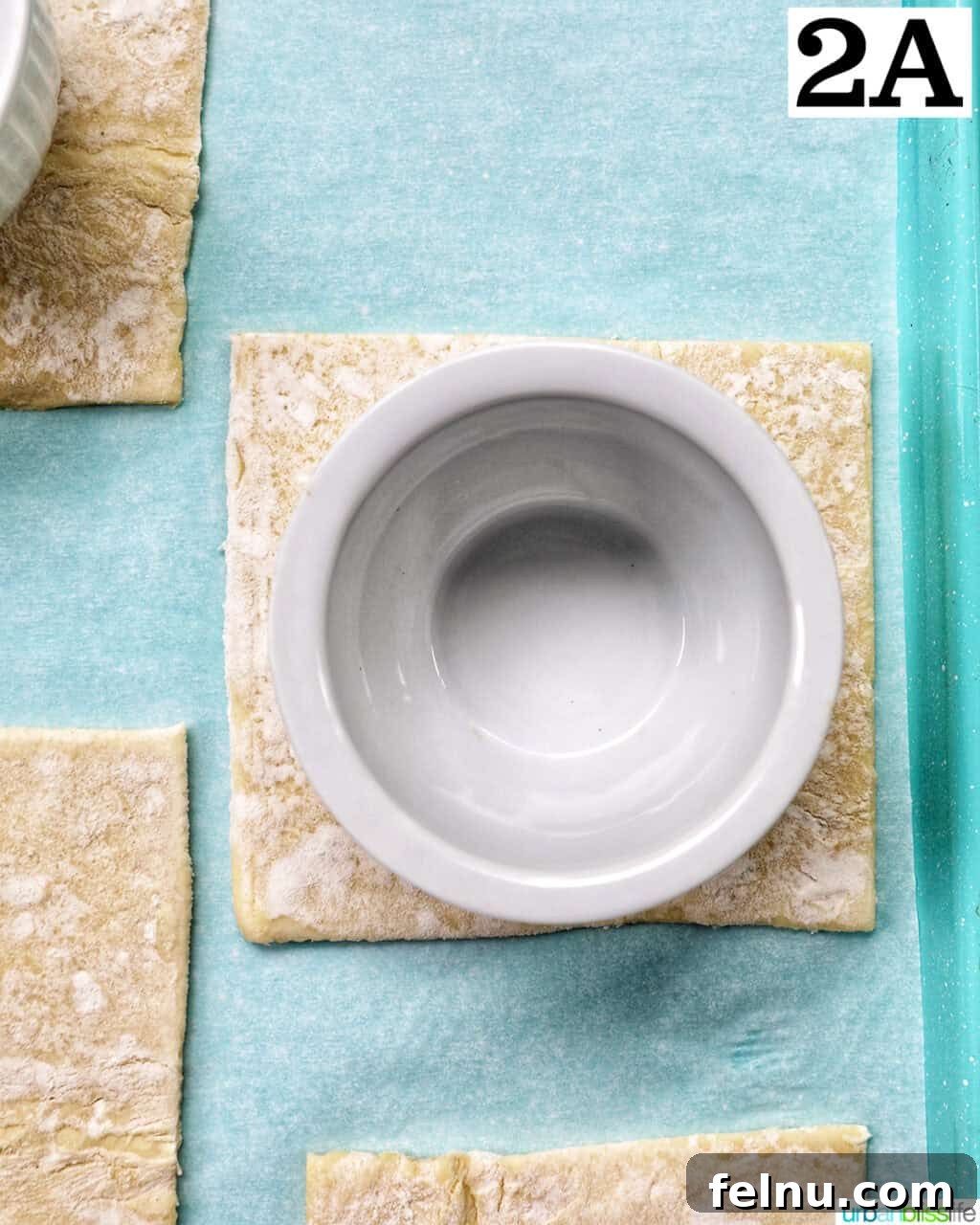 Golden Egg Parcels 6 A white ramekin placed on top of a puff pastry square to create an indentation for the egg.