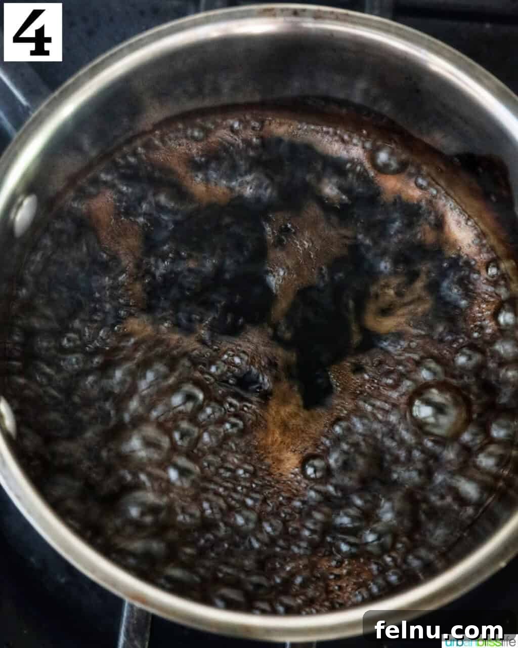 Crafting the Perfect Balsamic Reduction 7 Balsamic glaze boiling in a saucepan.