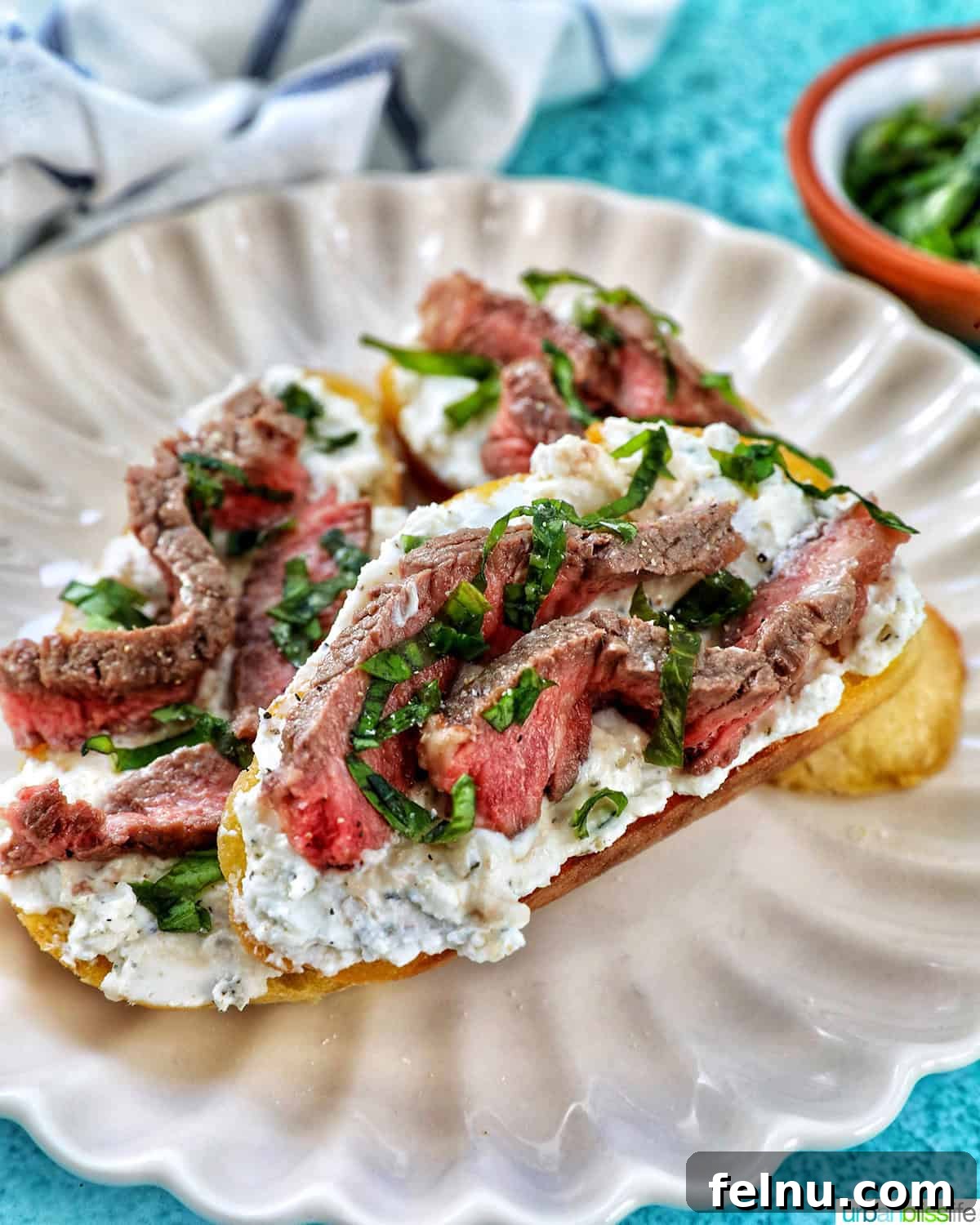 Steak Bites on Toasted Bread 18 Steak crostini on a plate