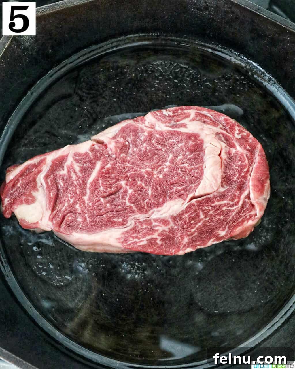 Steak Bites on Toasted Bread 10 Raw steak in a cast iron skillet