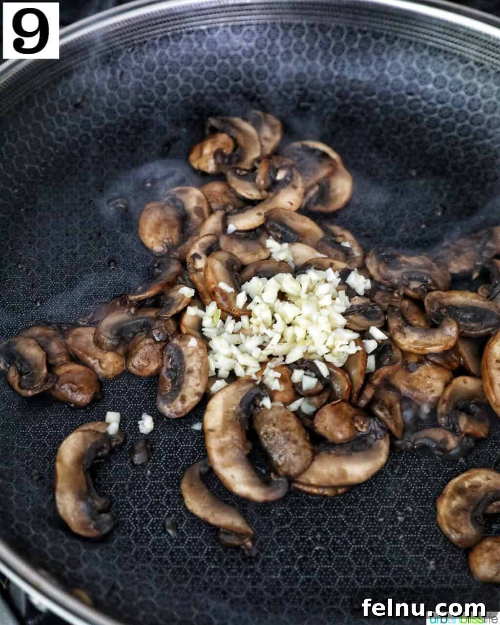 Savory Mushroom Toasts 13 Minced garlic being added to the cooked sliced mushrooms in a cast iron skillet for additional flavor.