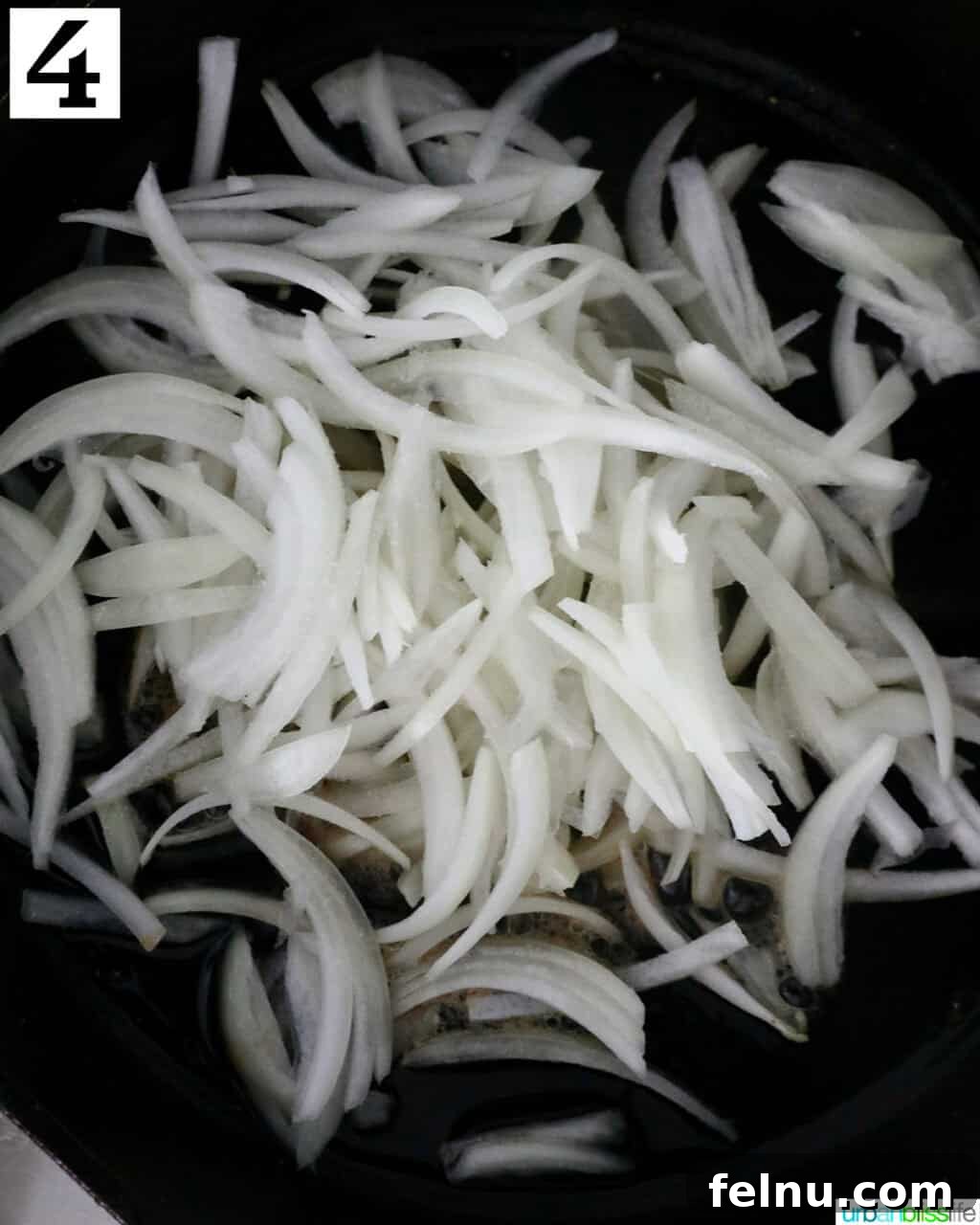 Savory Mushroom Toasts 8 Thinly sliced yellow onions added to a cast iron skillet with melted butter and oil, beginning to cook.