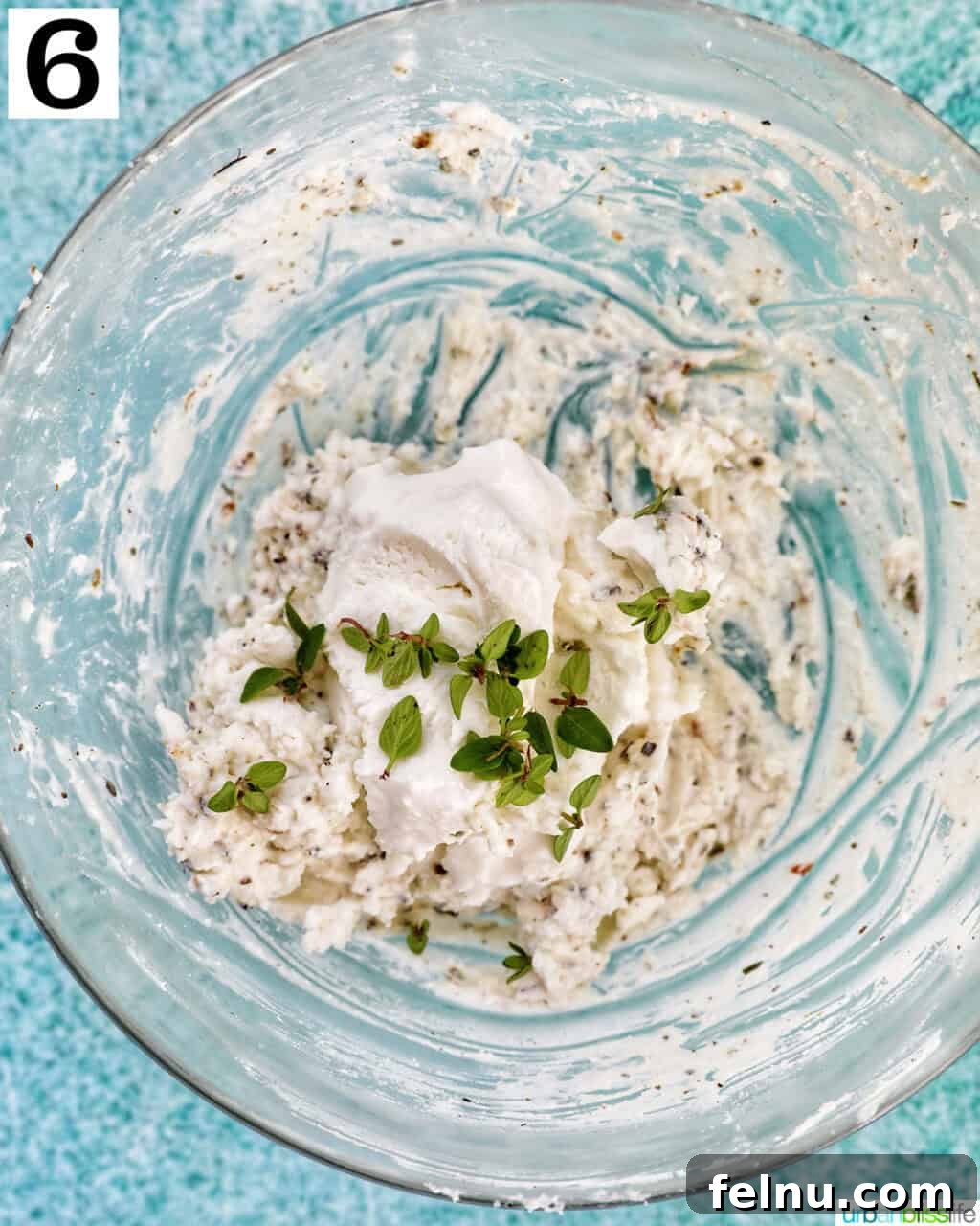 Savory Mushroom Toasts 10 A bowl containing creamy herbed goat cheese spread, mixed and ready.