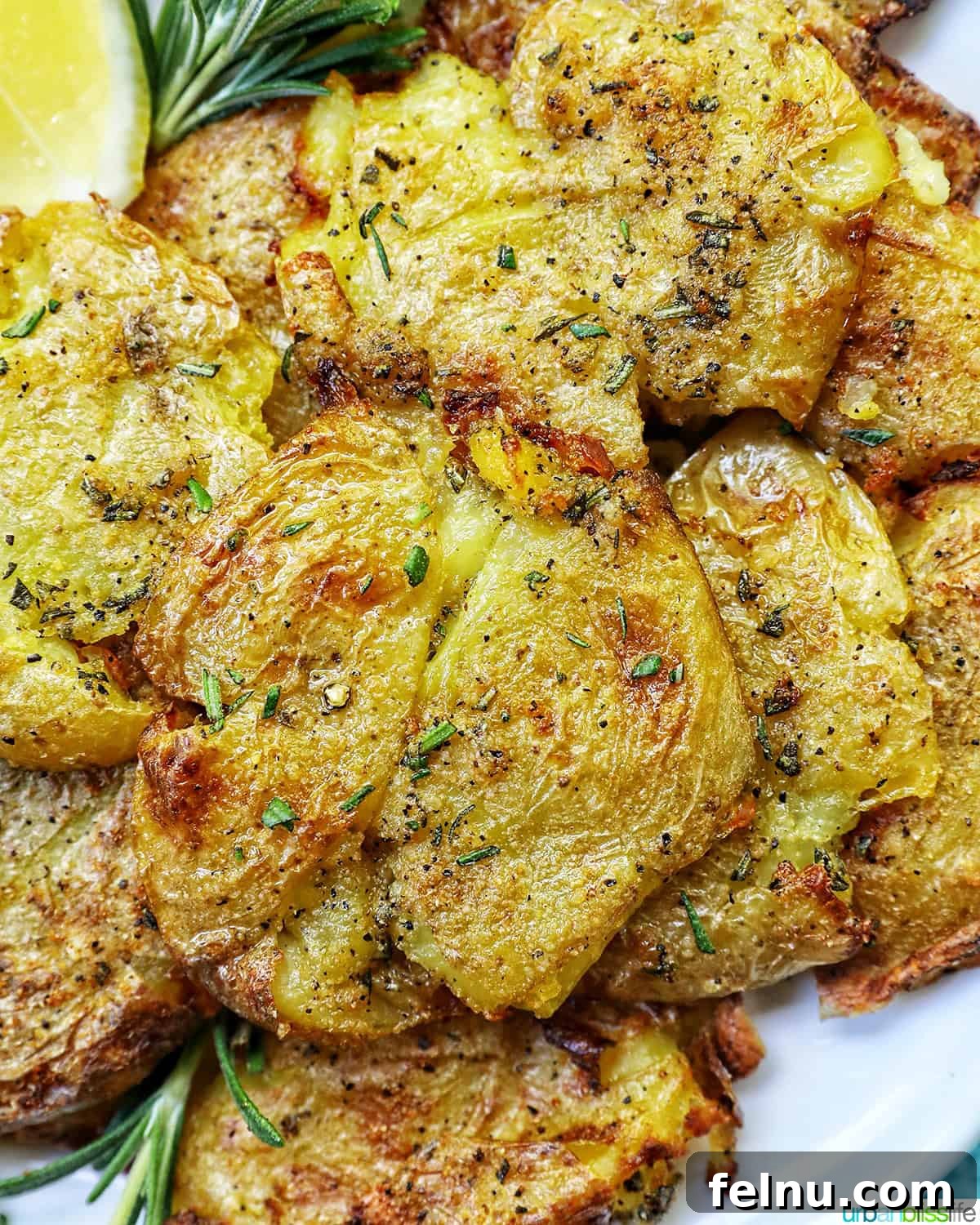 Crispy Air-Fried Smashed Potatoes 19 A close-up shot of crispy, golden smashed potatoes on a plate, garnished with fresh herbs.