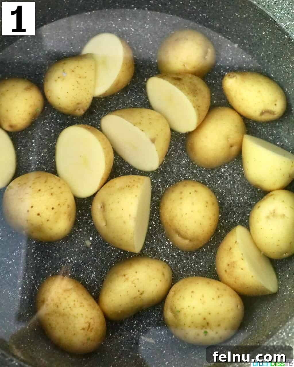 Crispy Air-Fried Smashed Potatoes 5 Halved baby gold potatoes soaking in water within a large pot, ready for boiling.